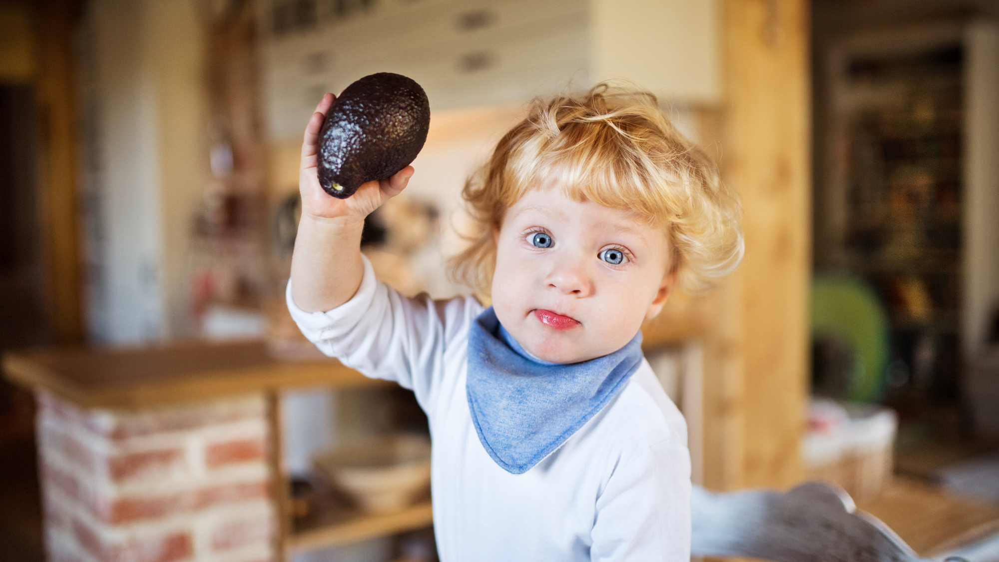 6-month-old baby demonstrating developmental readiness signs for starting solid foods safely