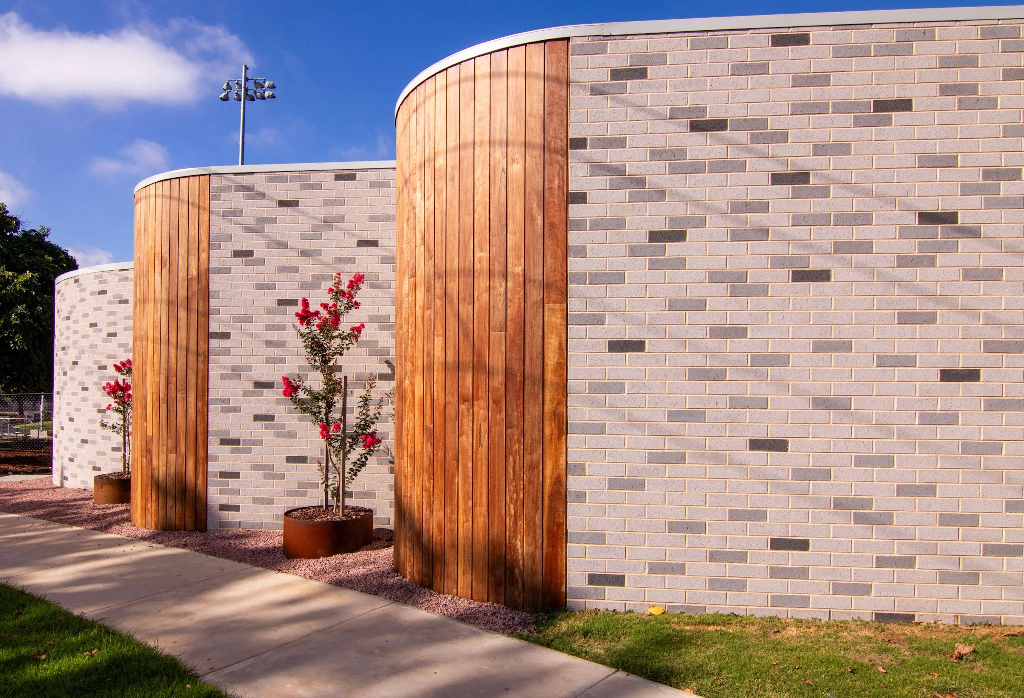 Melville Oval Pavilion, curved brick walls with timber panelling