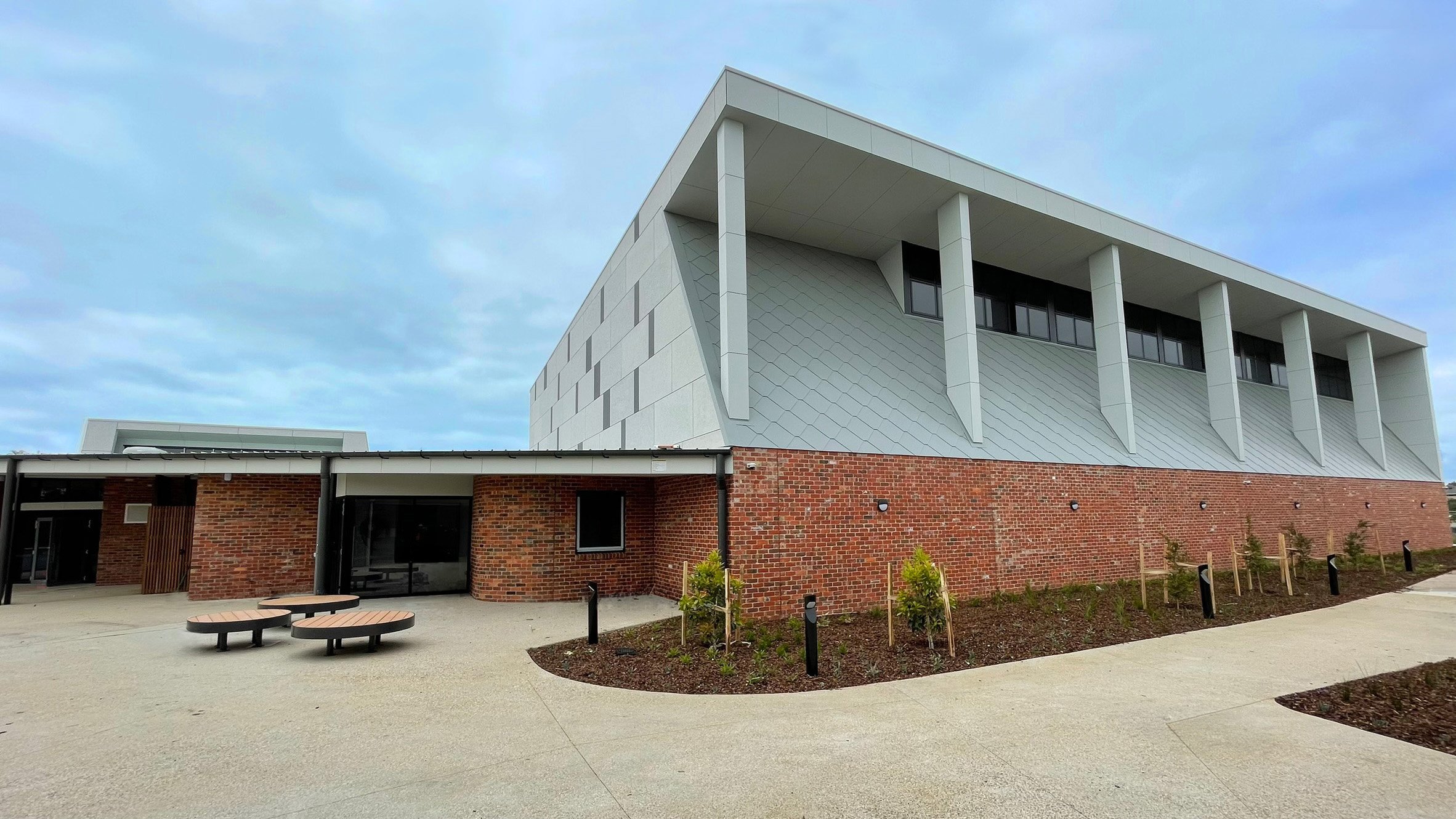 Jamieson Way Community Sports Hall and Pavilion, recyled brick walls, metal shigles cladding, outdoor seating