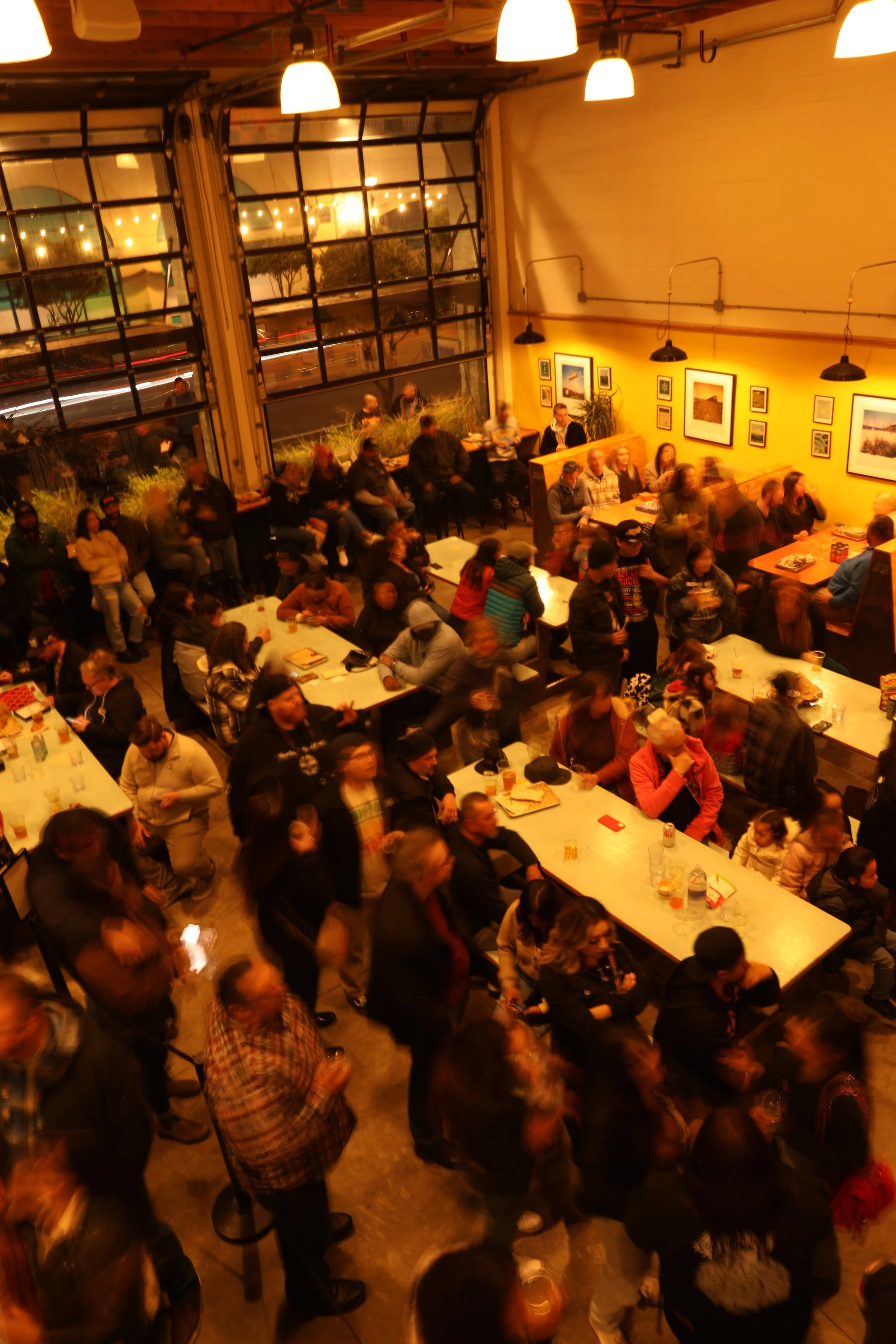 A large crowd of people at the Other Brother Beer Brewery in Seaside California