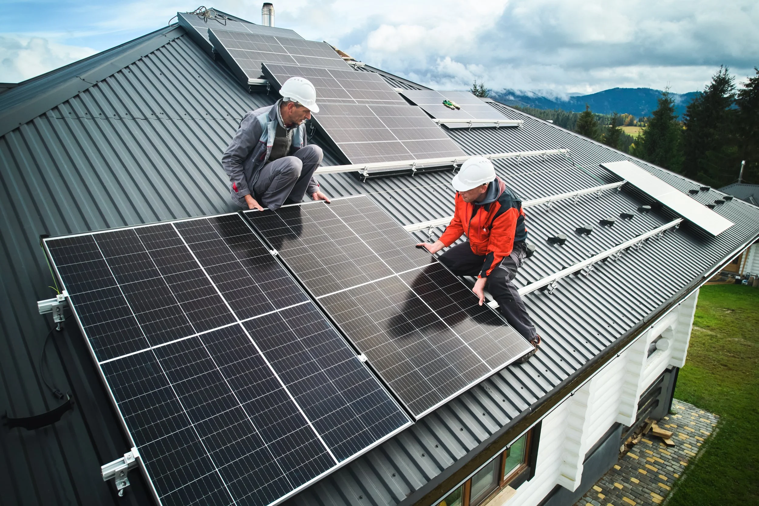 men-workers-installing-solar-panels-on-roof-of-hou-2023-11-27-04-51-54-utc.jpg