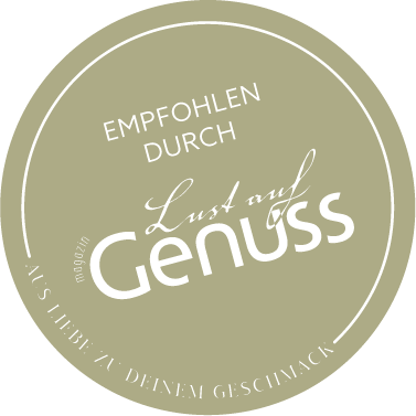 Grünes Siegel mit der Aufschrift "Empfohlen durch Lust auf Genuss" in Weiß.