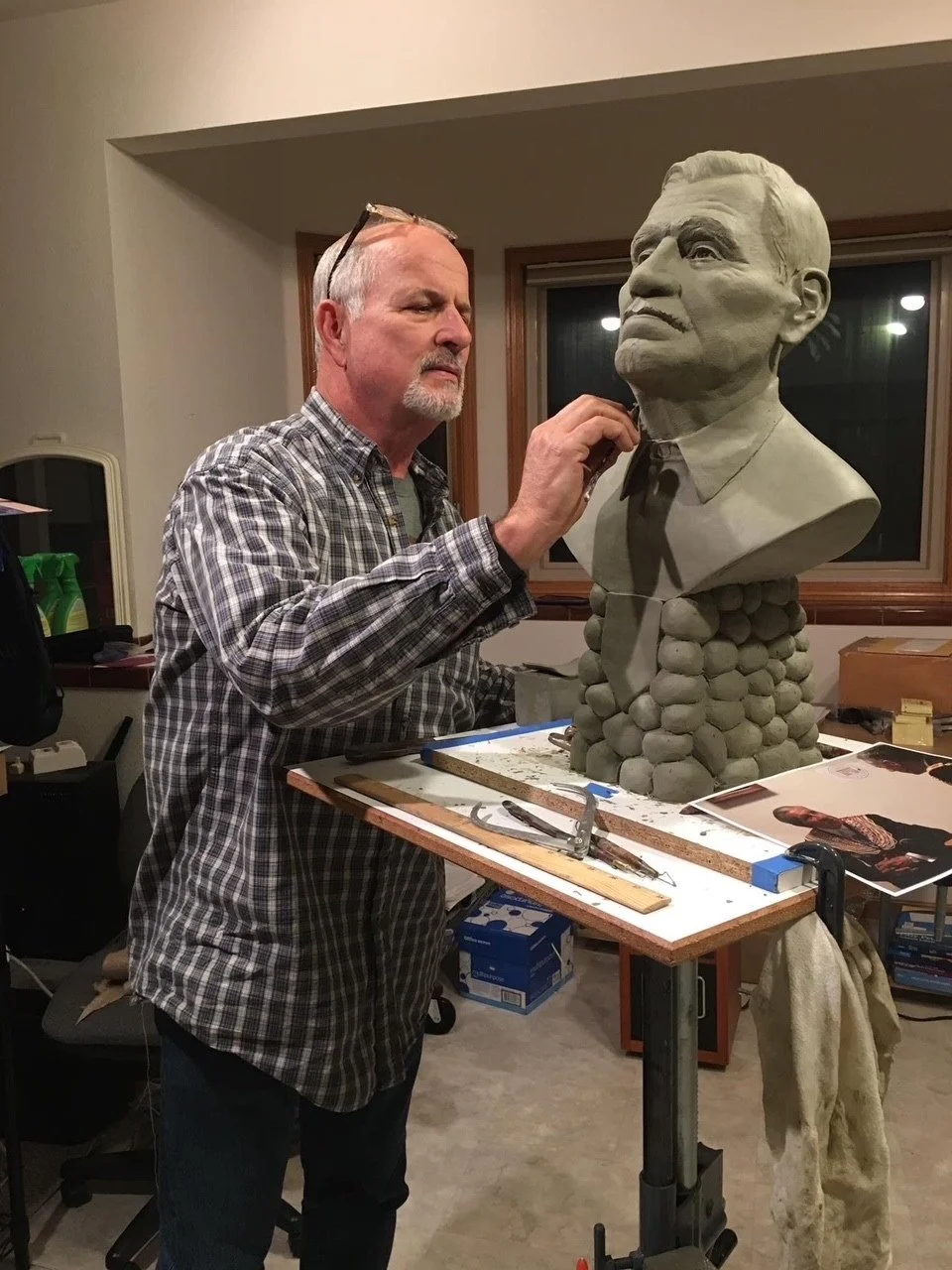 Stephen Spears sculpting a portrait bust in his studio