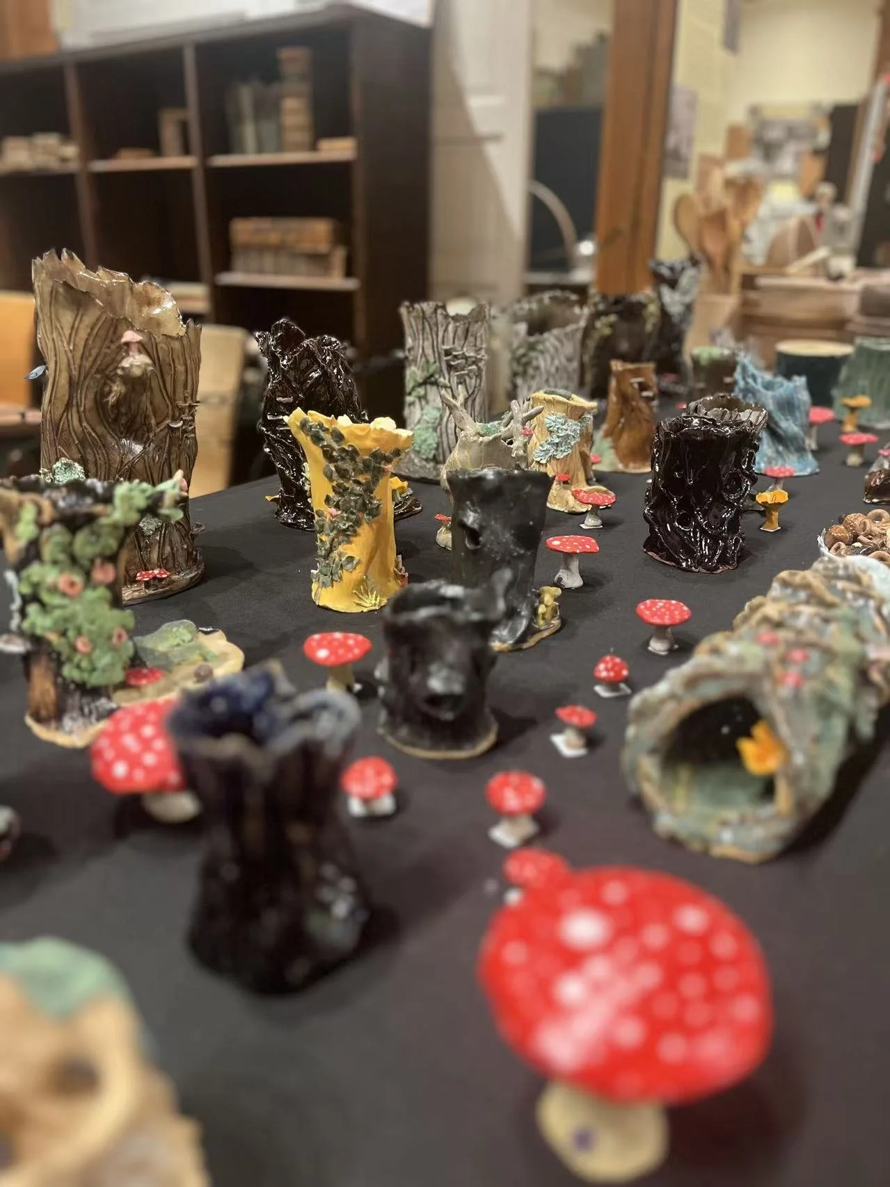 Ceramic vessels and sculptural mushrooms displayed at the Holiday Gift Show.