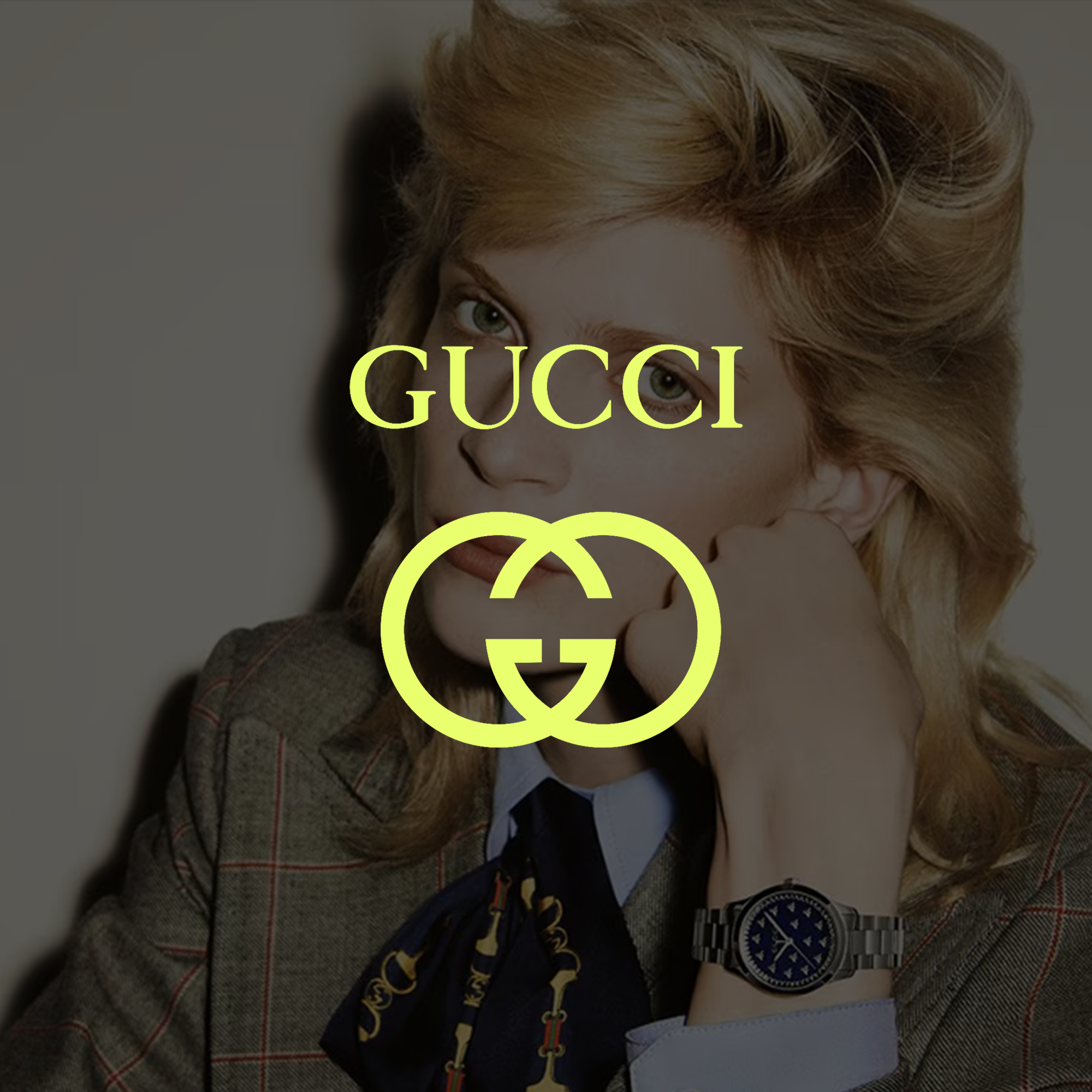 A woman with red hair resting her chin on her hand, wearing a watch and Gucci logo text overlay in front of her face.