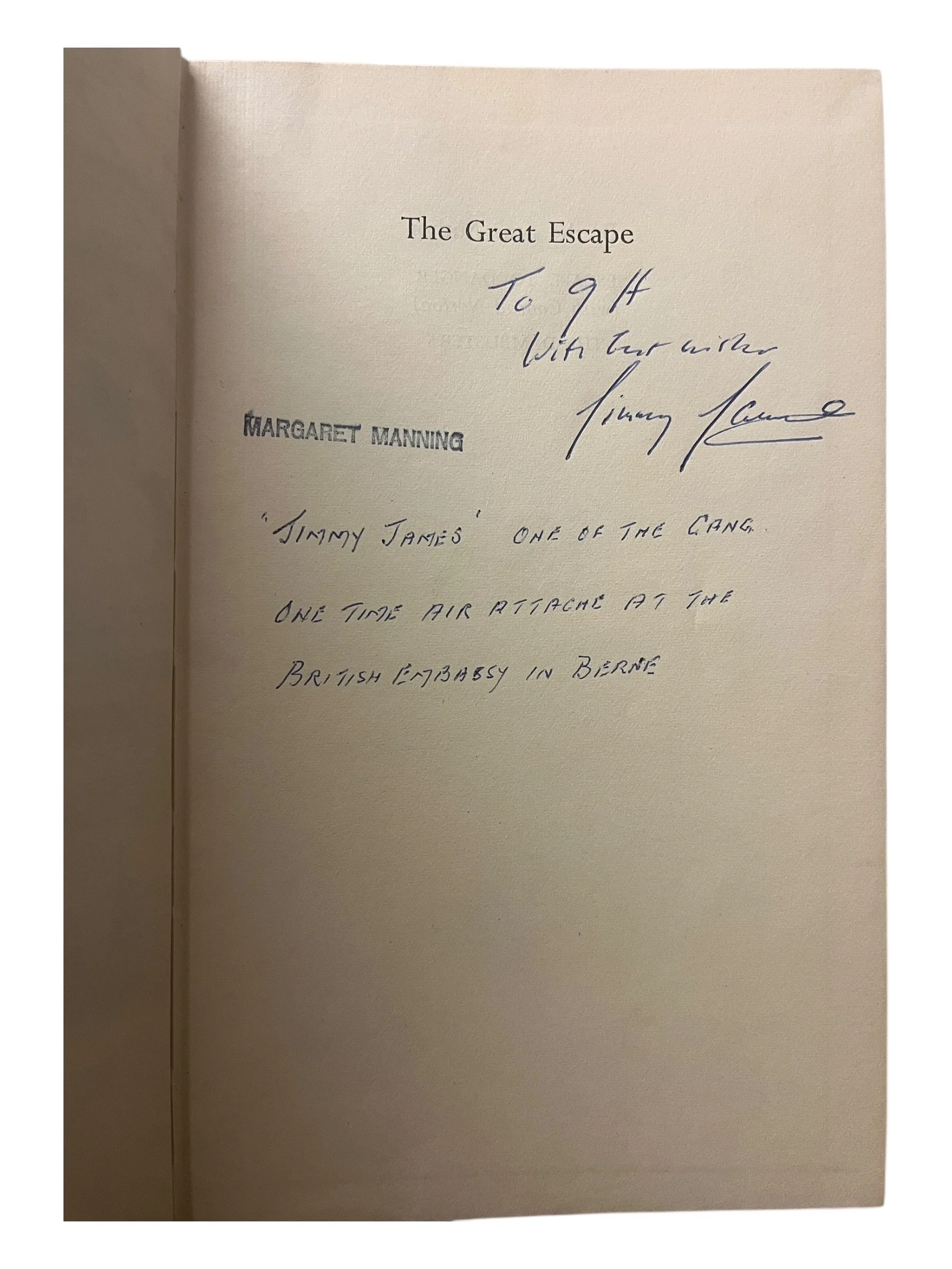 A hardcover book open to a page with handwritten notes and printed text. The printed text includes the title 'The Great Escape' and the name 'Margaret Manning'. The handwritten notes are addressed to 'G H' with a message about James and the gang, mentioning a brief attack in Bern.