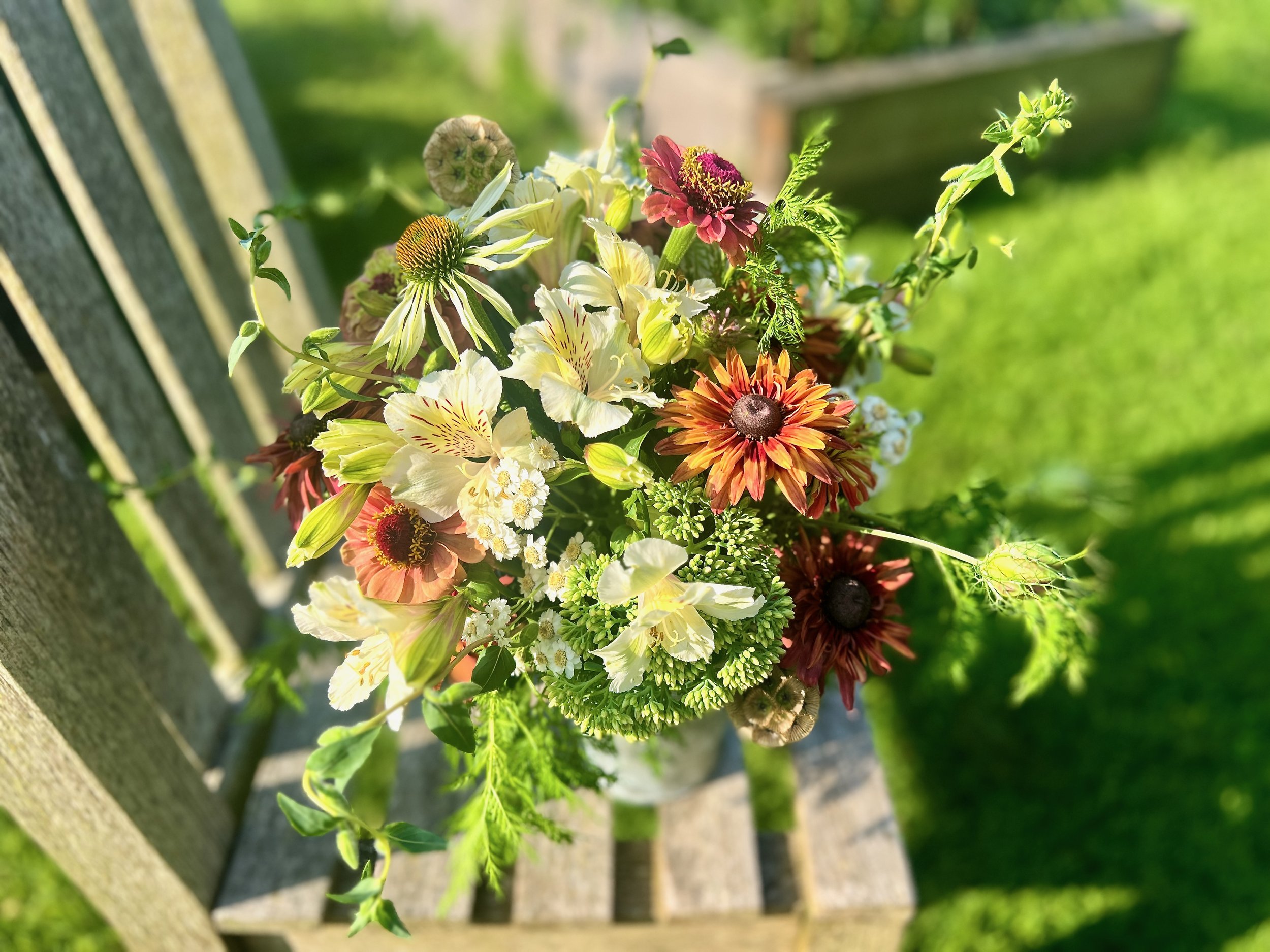 Floral table arrangement with cream and orange flowers