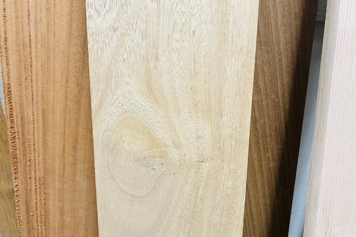 Close-up of several different types of wood planks with varying shades and grain patterns.