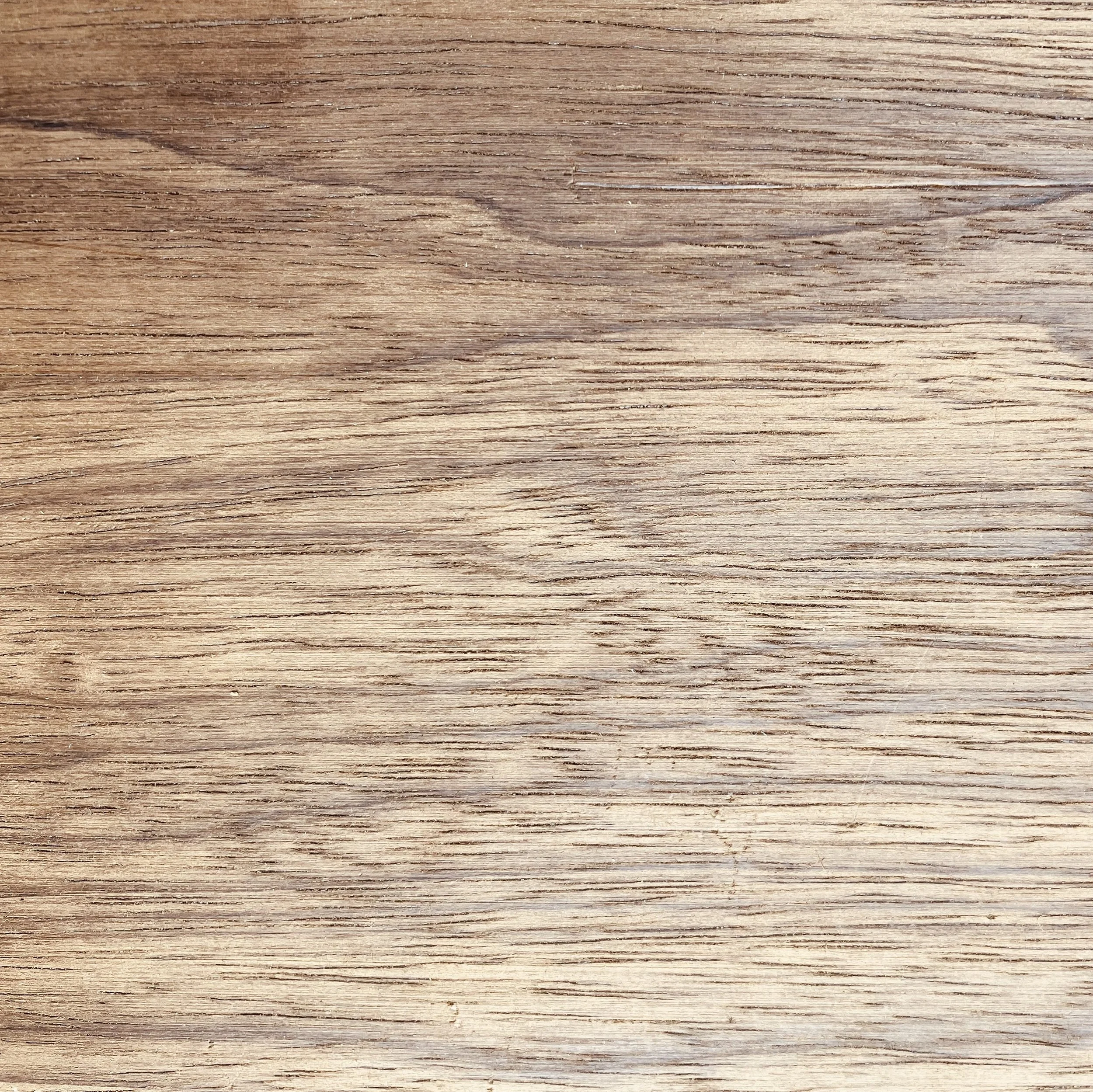 Close-up of a wooden surface with visible grain and texture.