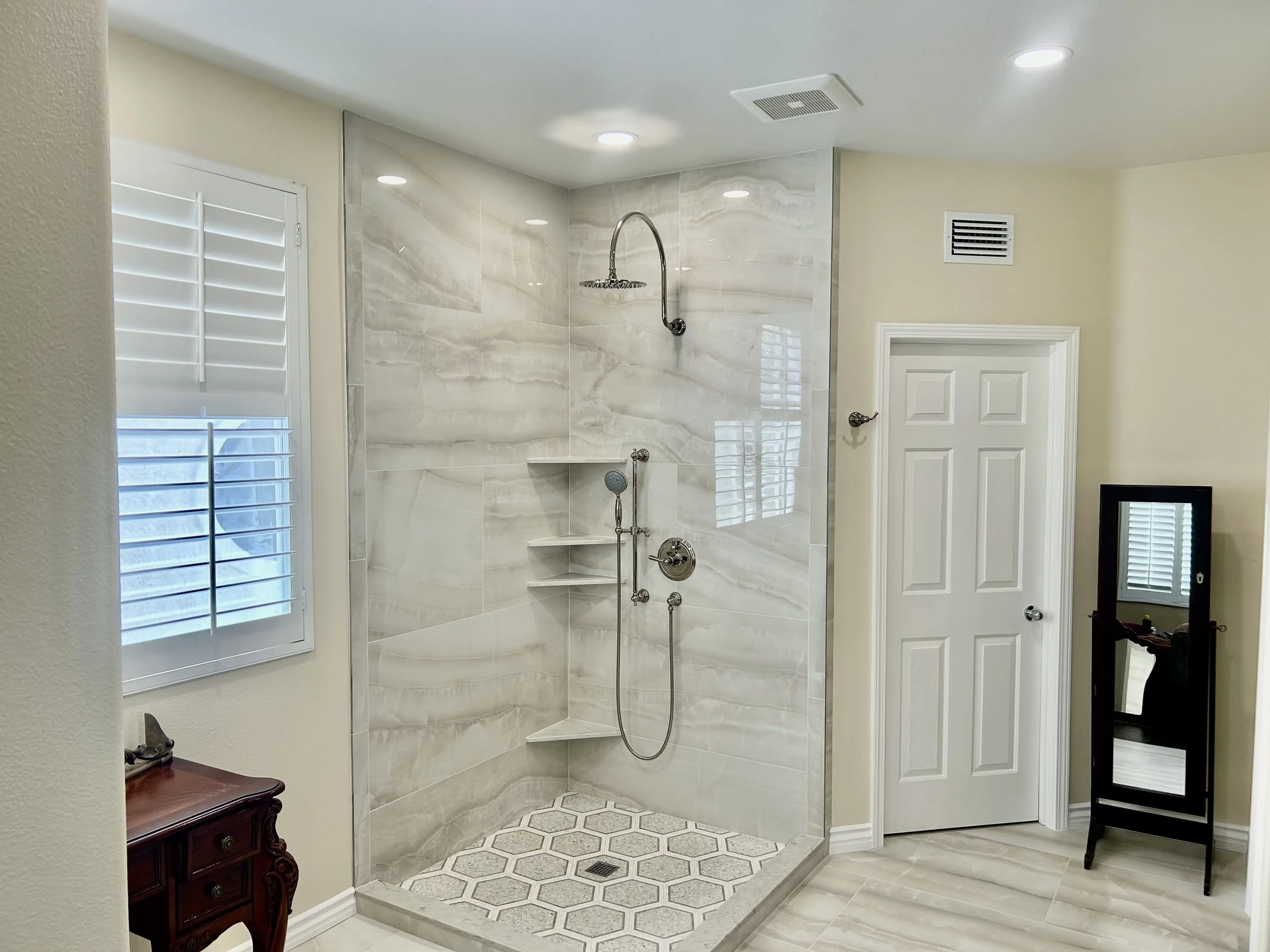 This Moorpark Master Bath Remodel Design removed a large Roman tub which then allowed a much larger shower to be constructed. The tile used in the shower is polished porcelain, the floor is honed porcelain. The shower trim is California Faucets brand