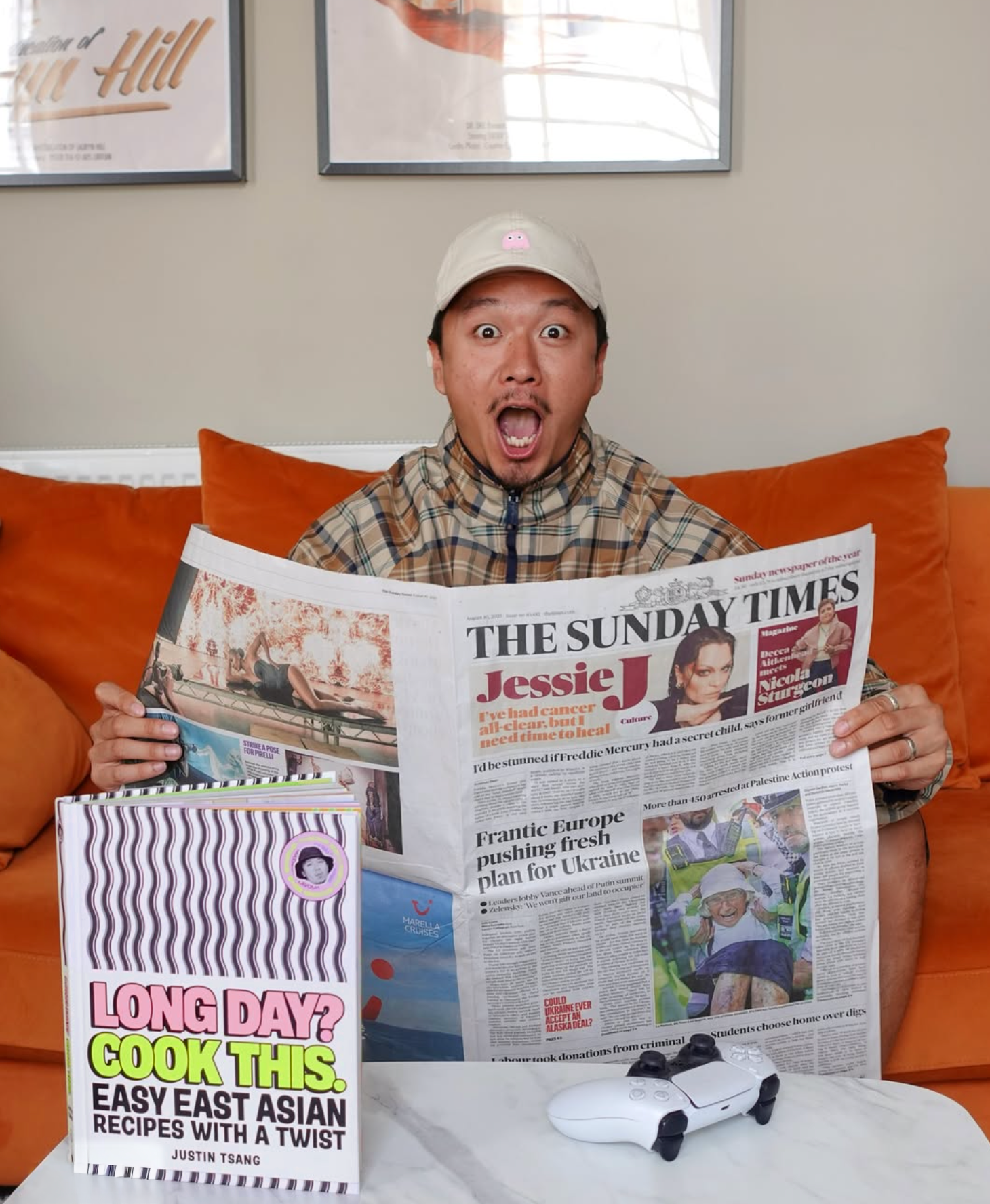 Justin Tsang discovers his debut cookbook designed by Blonder Brand is an instant bestseller. He is wearing a beige cap with a pink pig sticker and a plaid jacket.