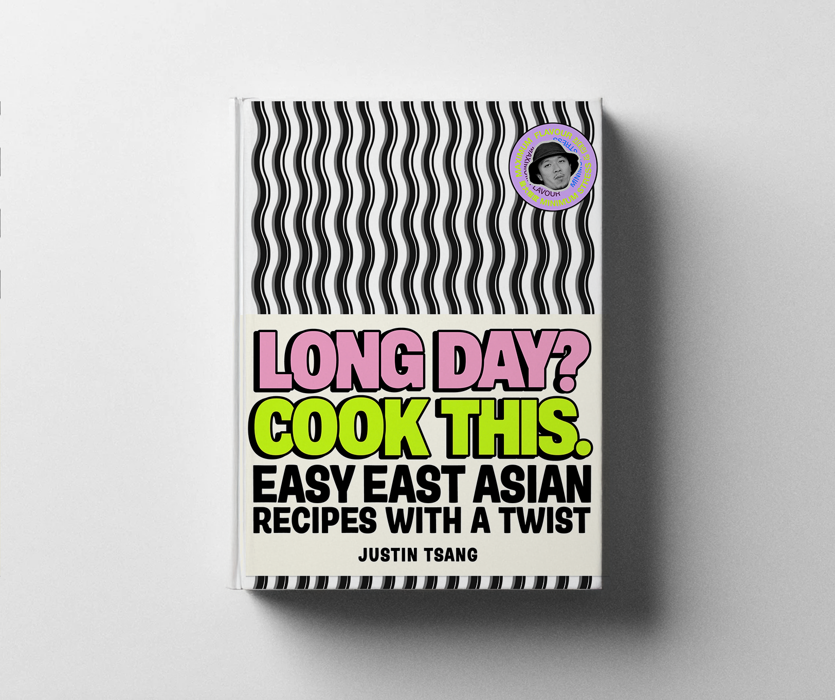 Book titled 'Long Day? Cook This. Easy East Asian Recipes with a Twist' by Justin Tsang with a black and white wavy pattern on the top and bottom, and a circular sticker with a person's face in the top right corner.