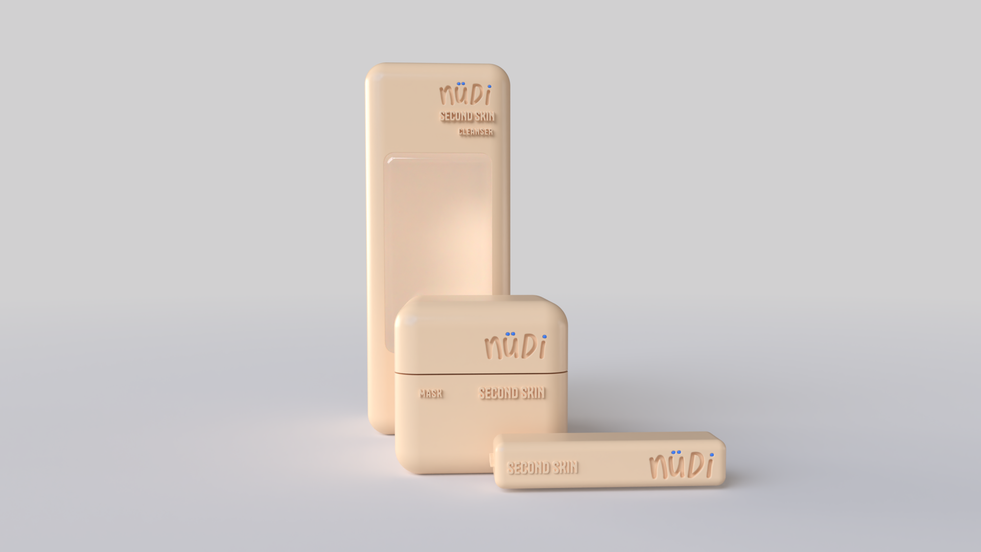 Three beige skincare products with the brand name 'Nüdi' visible, including a tall rectangular bottle, a square container, and a small rectangular item, all placed on a plain gray background.