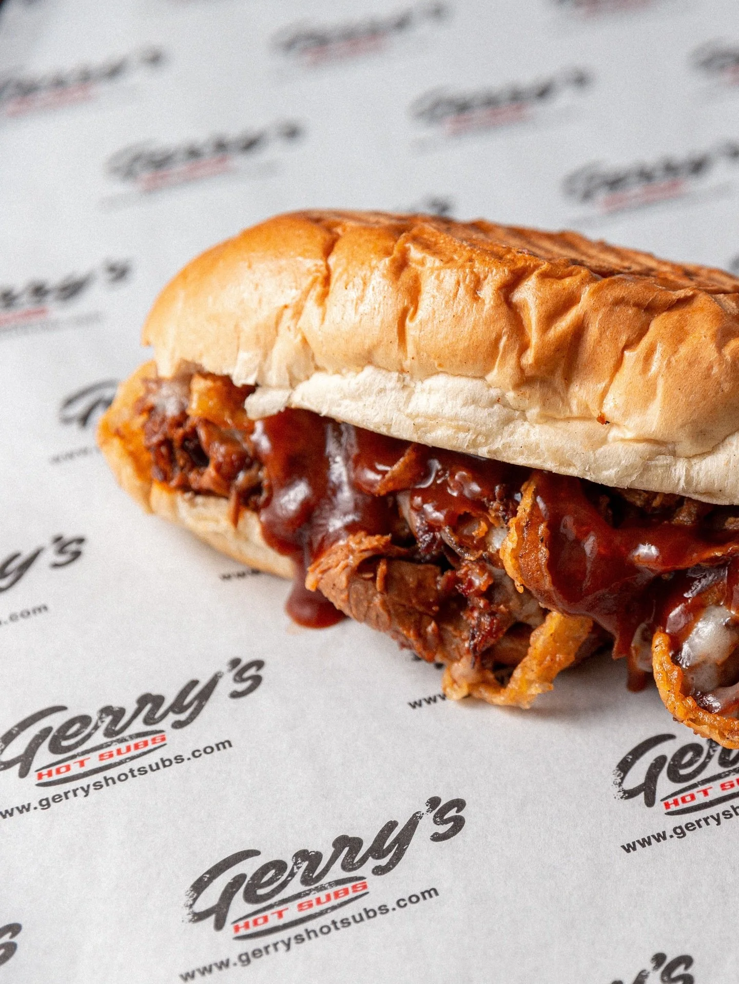 BBQ BRISKET 🤤 
Thinly sliced, slow-smoked brisket drenched in our house BBQ sauce, melted Emmental, and finished with golden crispy fried onions.