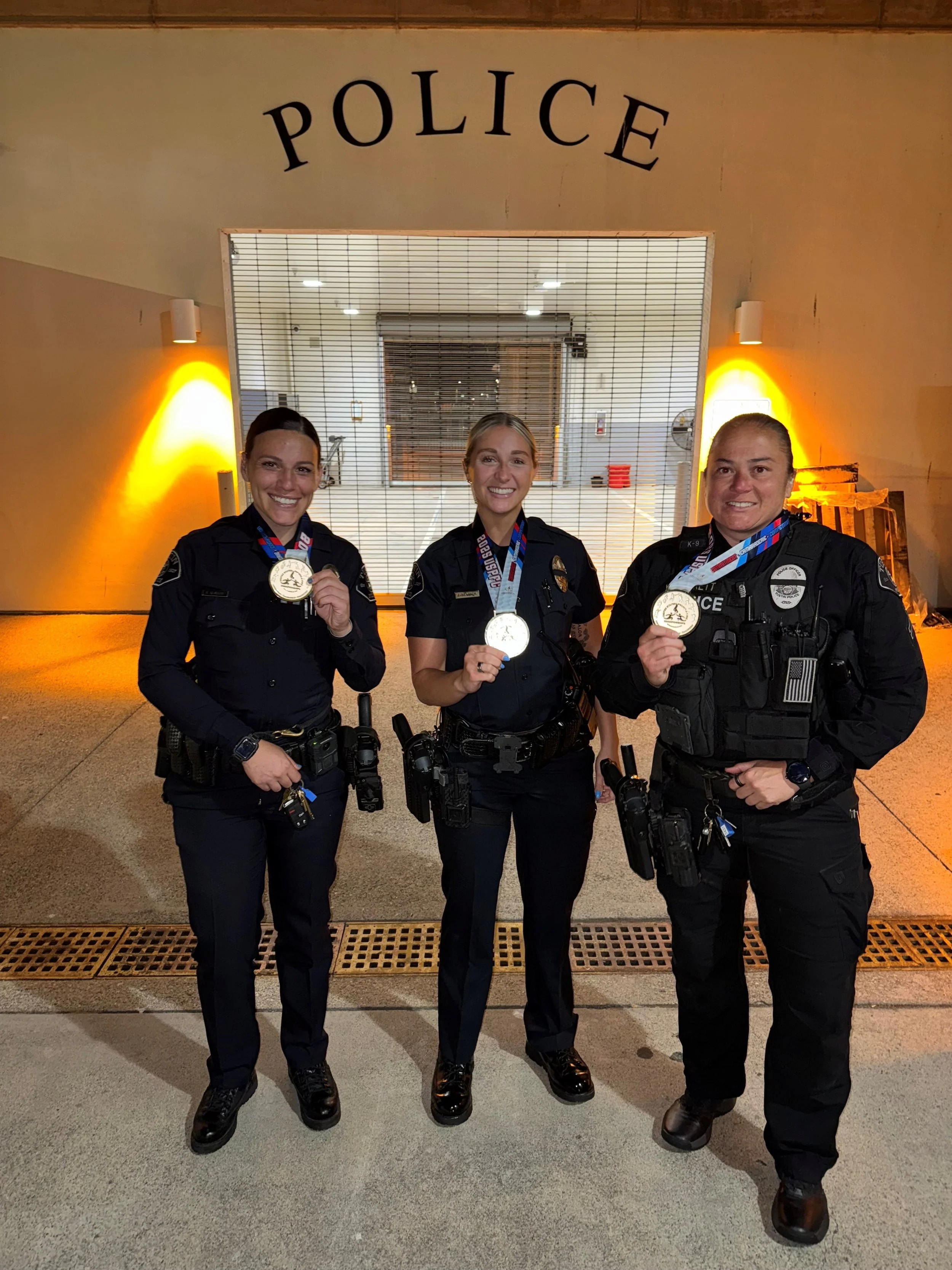 Brooke is pictured on the left, proudly holding her Police Games soccer medal, alongside Officer Evans and Foundation President Barrett.