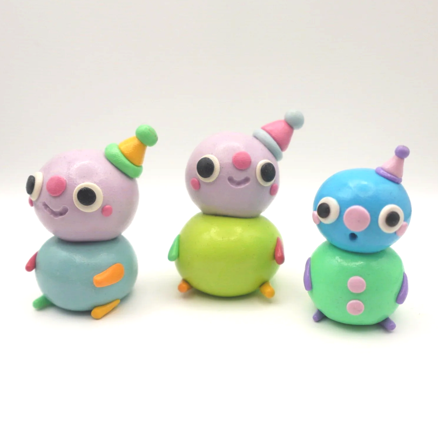 Colorful Clay Creatures that look like people / babies