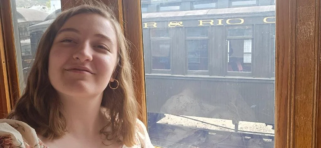 Noelle sitting on a train :)
