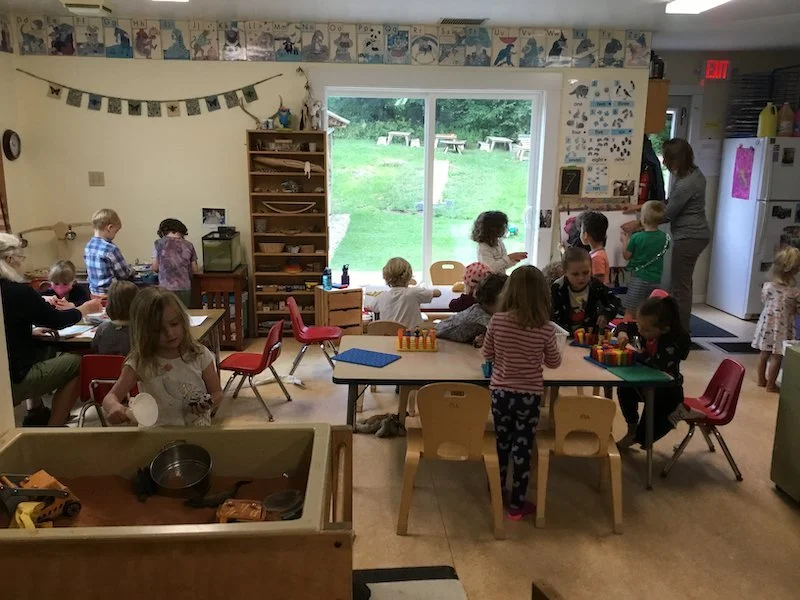 Kids and teachers in a preschool class cooperating with each other