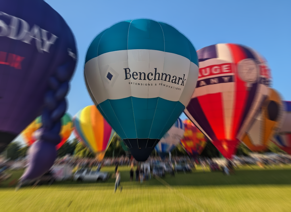 Benchmark branded inflatable hot air balloon at a large outdoor event