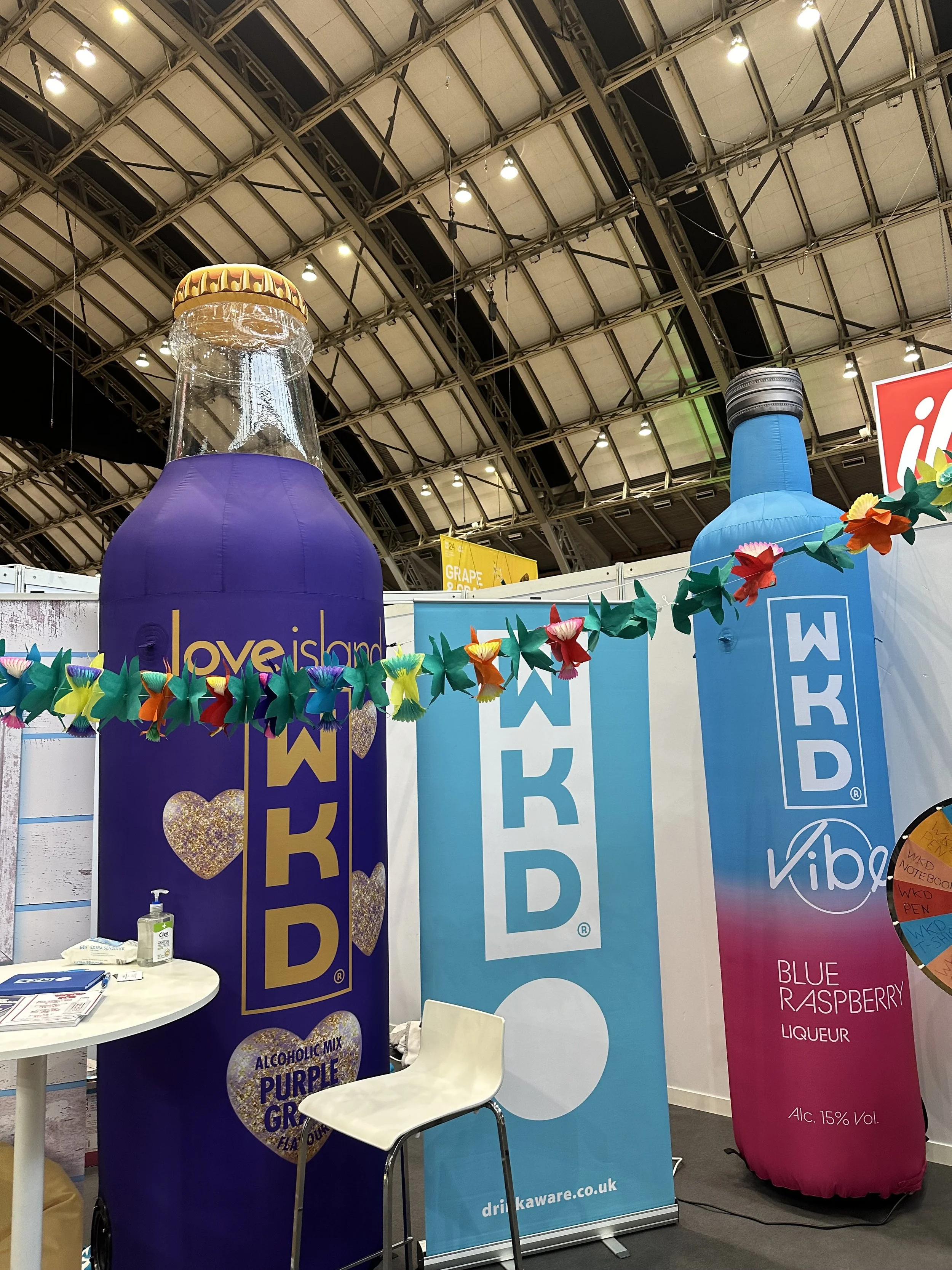 Large inflatable product replicas displayed at an exhibition stand to promote the WKD brand and attract visitors