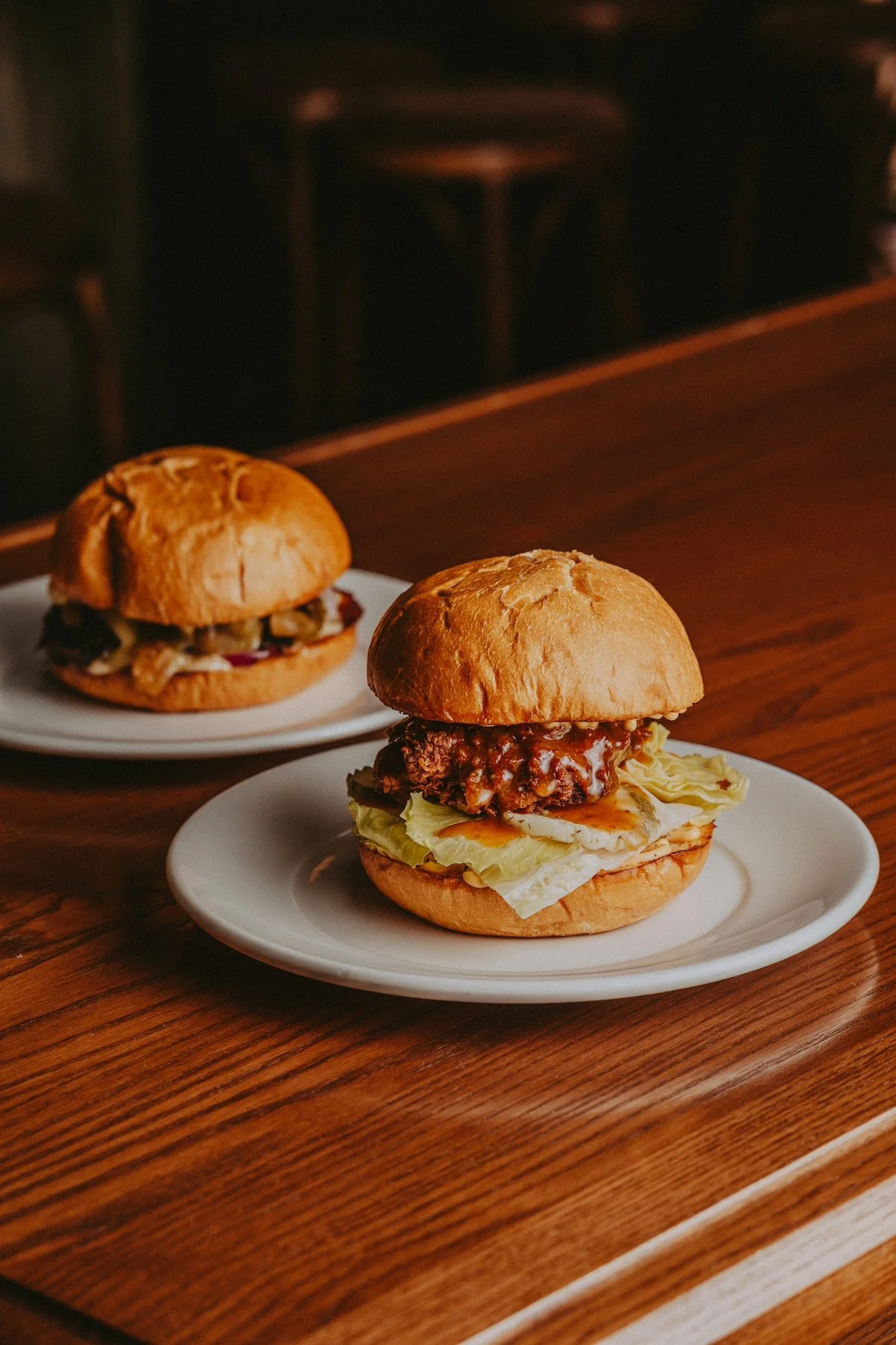 A beef cheeseburger and a fried chicken burger at Twofold Bistro Brewery