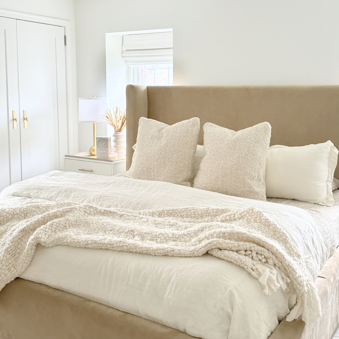 Warm neutral textured cozy primary bedroom.png