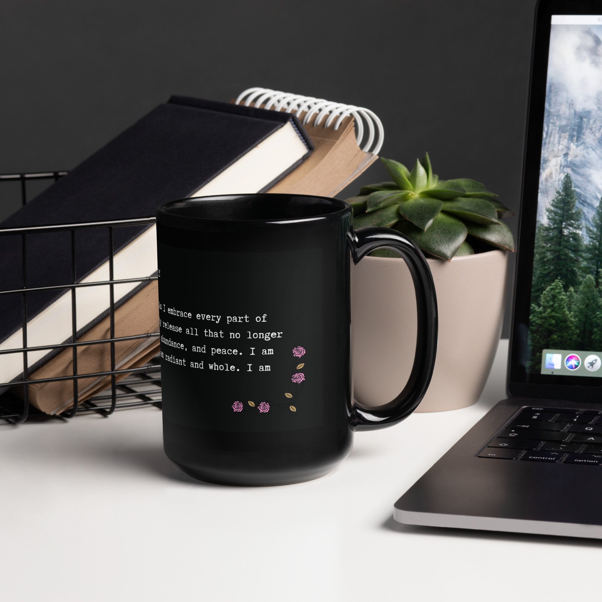 Black glossy 15 oz mug with sacred affirmation on cozy morning table, styled with coffee, journal, and flowers.