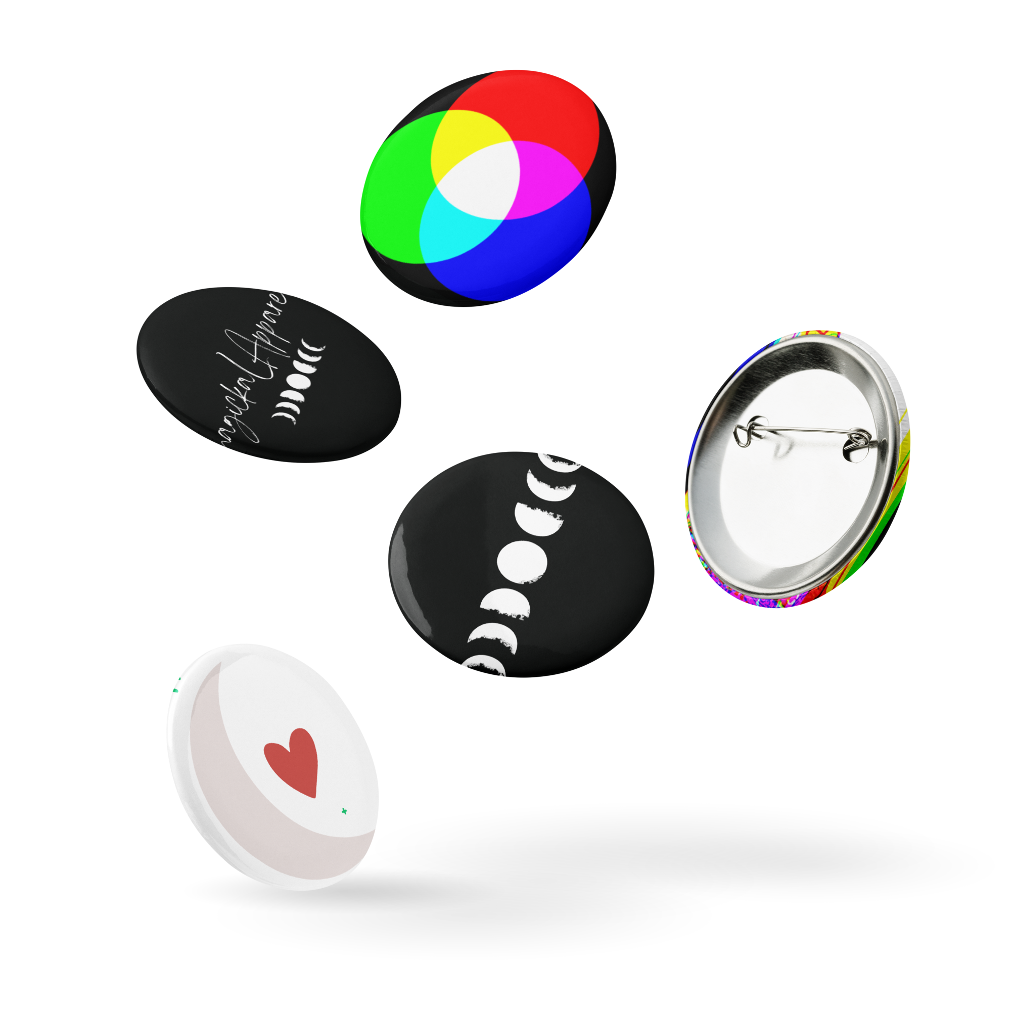Collection of buttons with different designs: a rainbow-colored circle, a black button with white moon phases and text, a black button with white moon phases, a white button with a red heart, and a plain backing of a button.