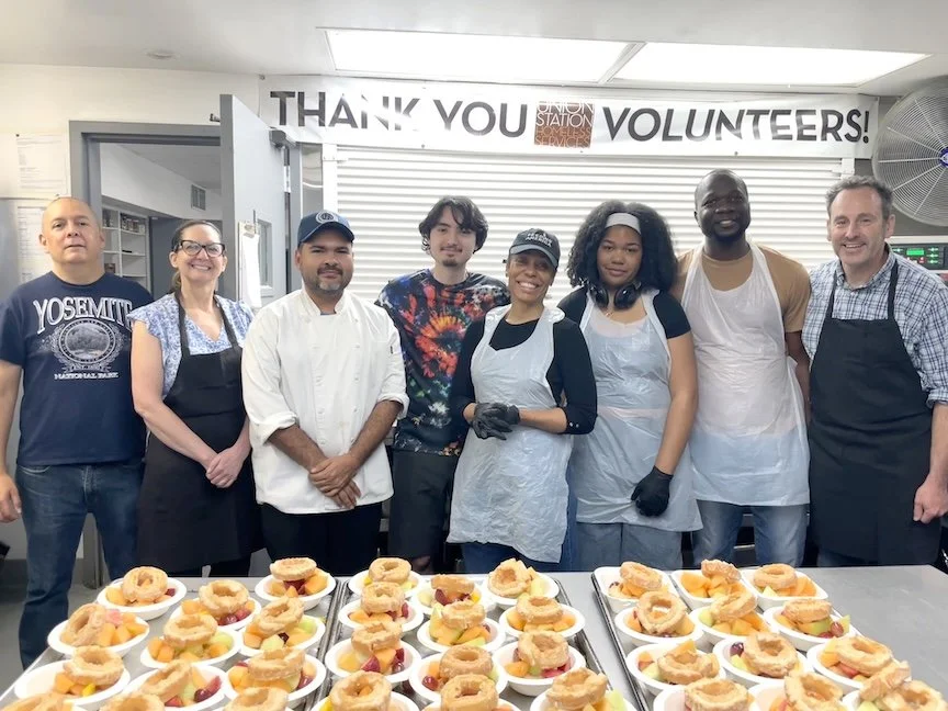 7 Volunteers and 1 USHS Kitchen Staff pose in front of the dessert they made that will be distributed to our residents at the Union Station Homeless Services Adult Center.