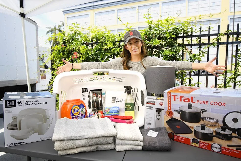 Volunteer collecting welcome home kits for program participants that include linens, laundry detergent, cleaning supplies, pots and pans, dishes and flatware. 