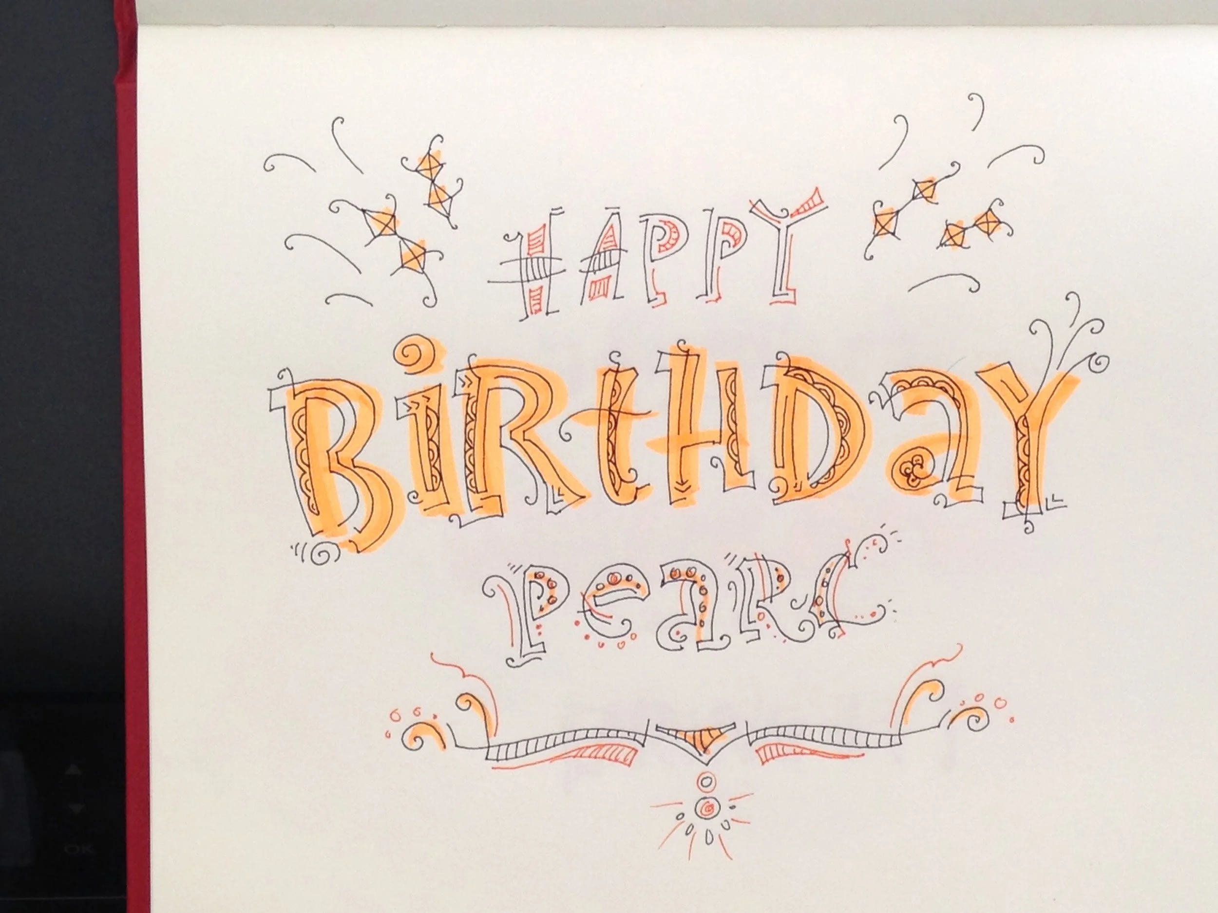 Hand-drawn card with the words 'Happy Birthday Pearc' in colorful, decorative lettering with stars and swirls.