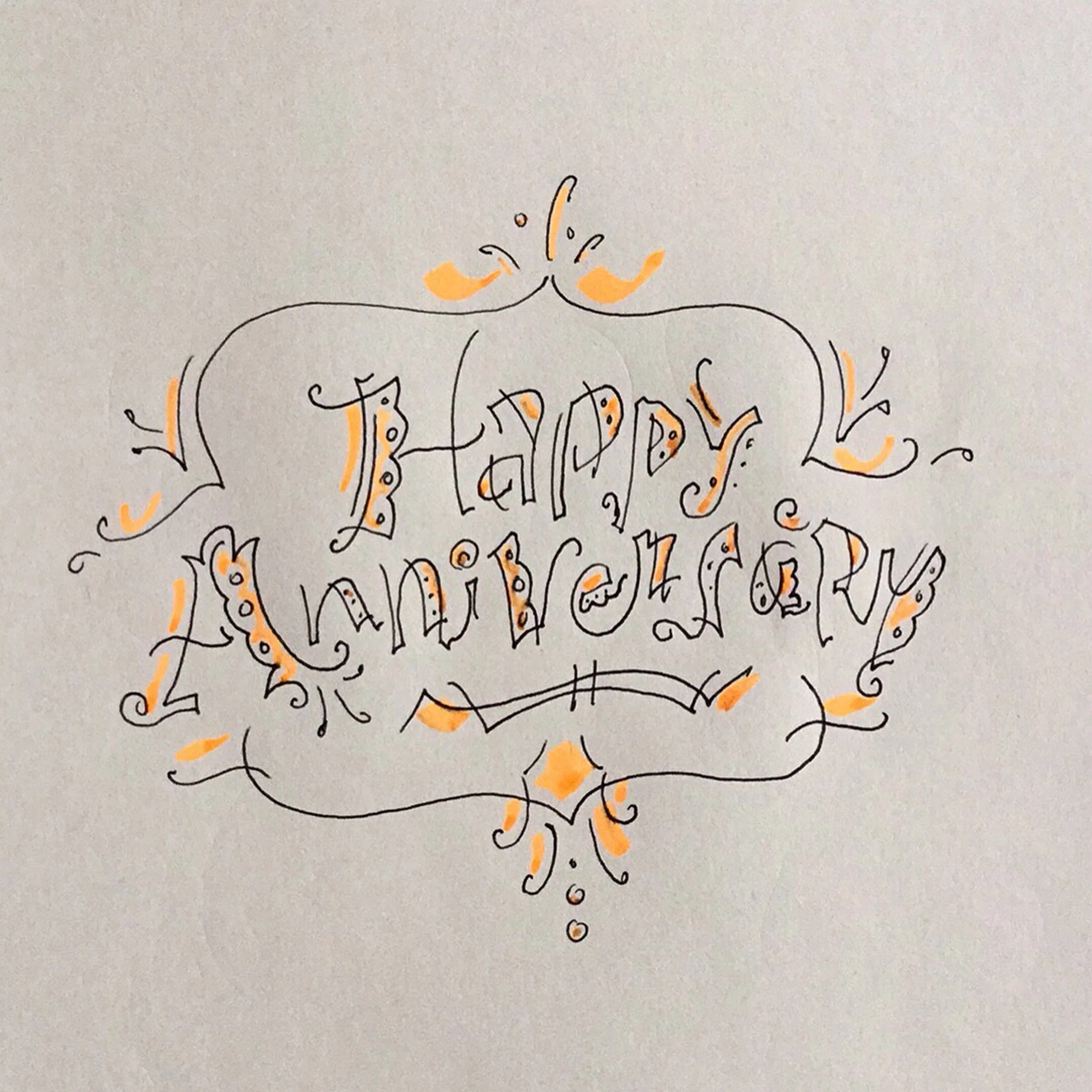 "Happy Anniversary" hand-drawn in decorative letters with orange accents on a white background.