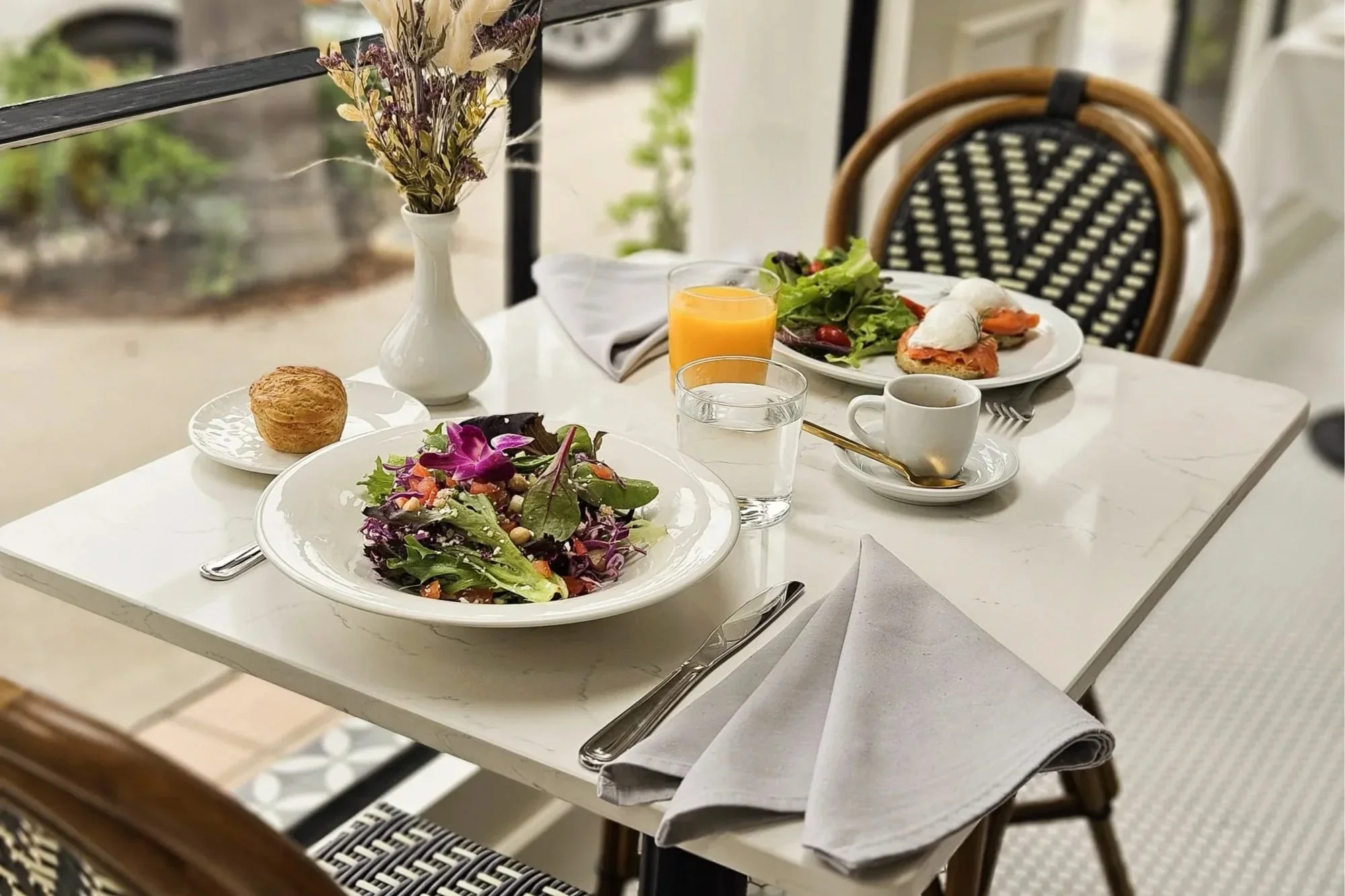 Brunch at Lilac Montecito with fresh salads, poached eggs, coffee and orange juice.
