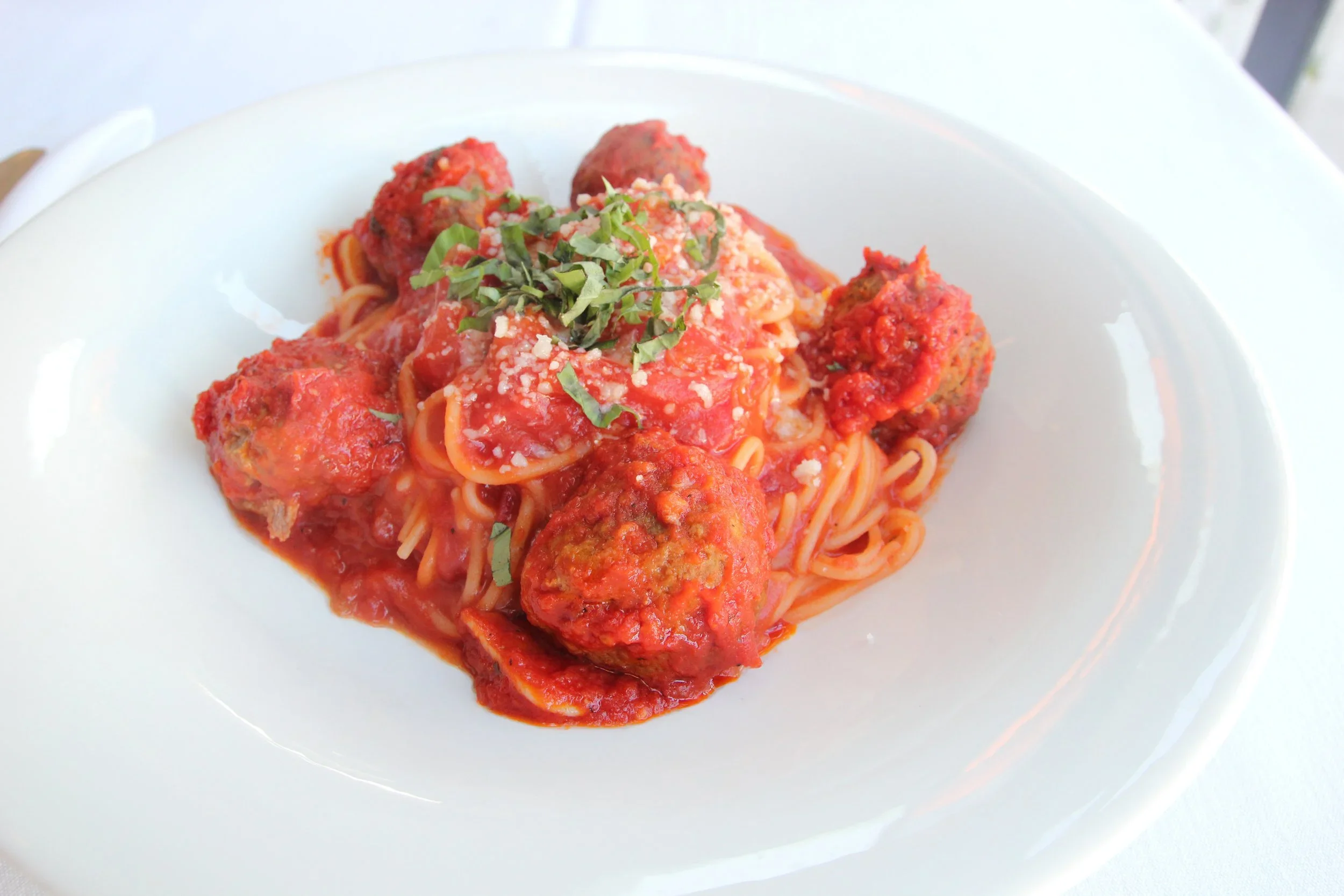 Spaghetti and meatballs in marinara with parmesan from Lilac Montecito, available for online ordering and local pickup.