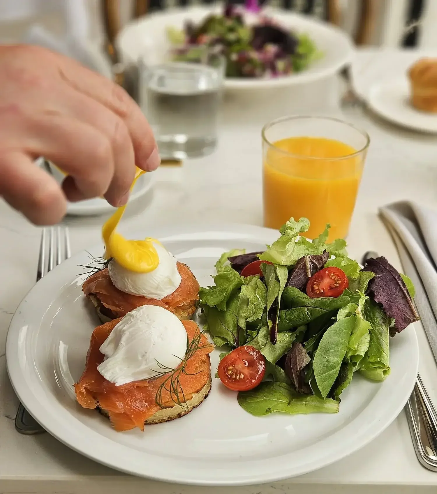 Brunch plate with smoked salmon eggs Benedict at Lilac Montecito, showcasing the dining experience available with a restaurant gift card.