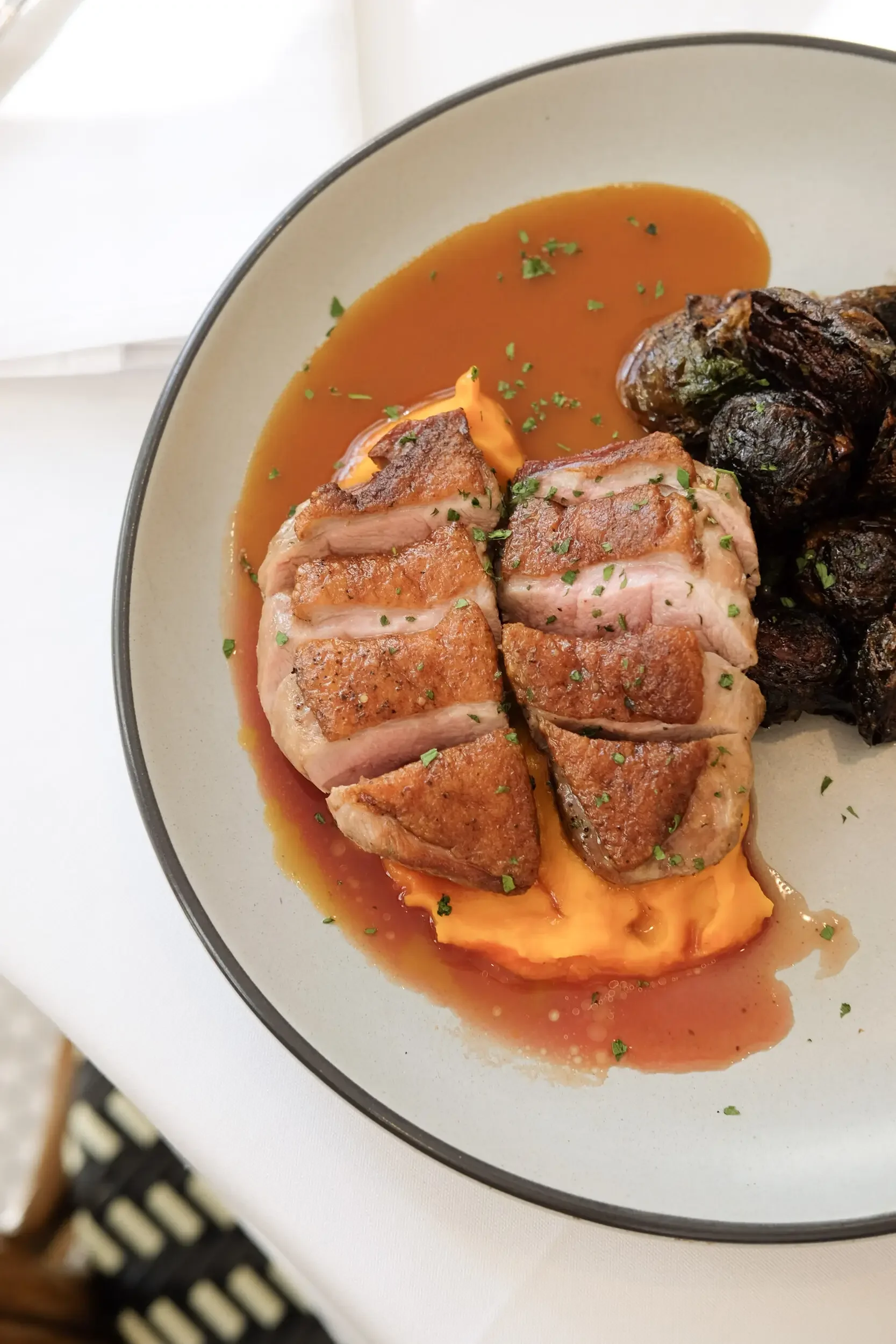Seared duck breast with crispy brussels sprouts and butternut squash purée at Lilac Montecito