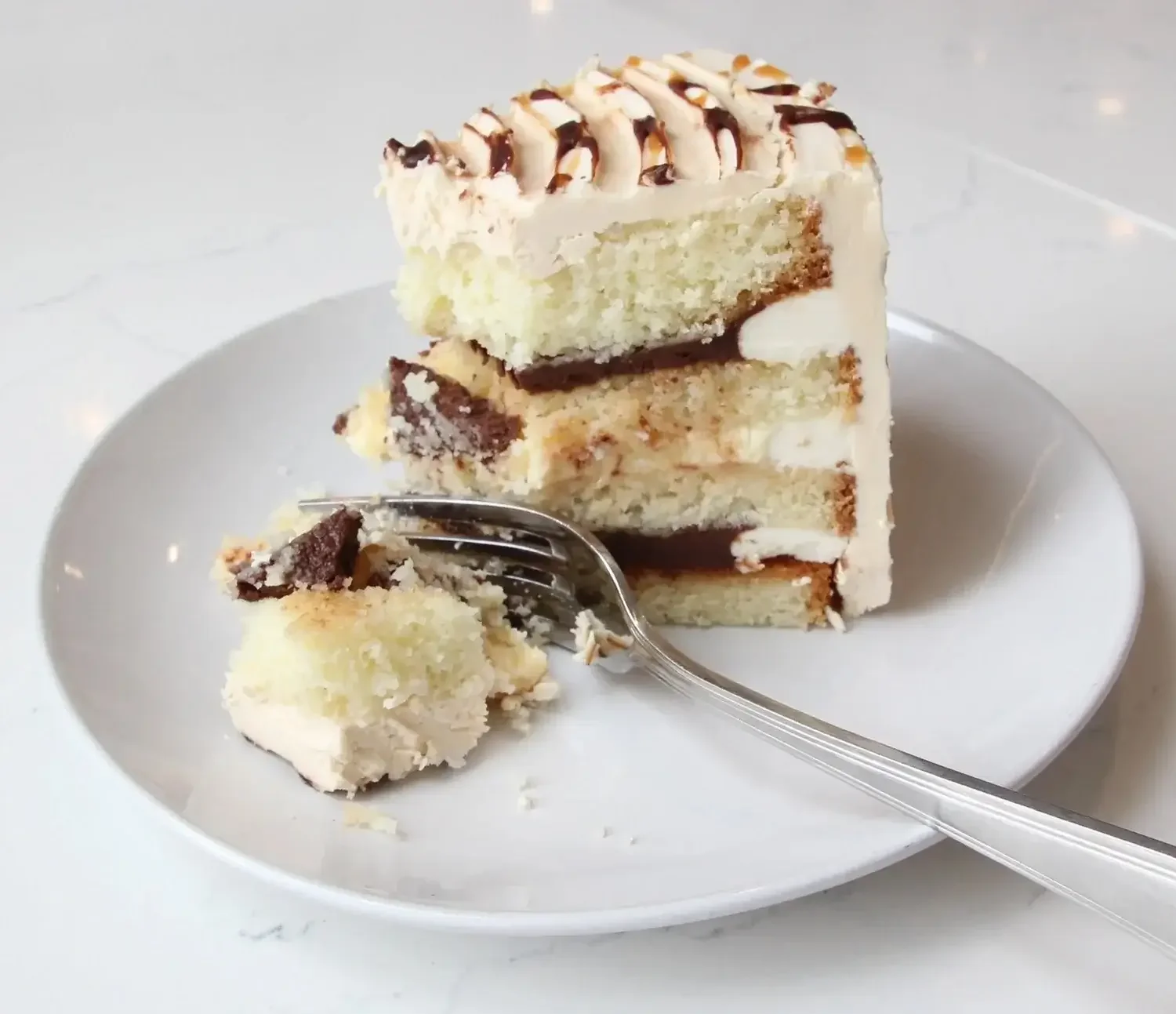 Slice of layered cake at Lilac Montecito, highlighting the sweet treats available with a restaurant dining gift card.