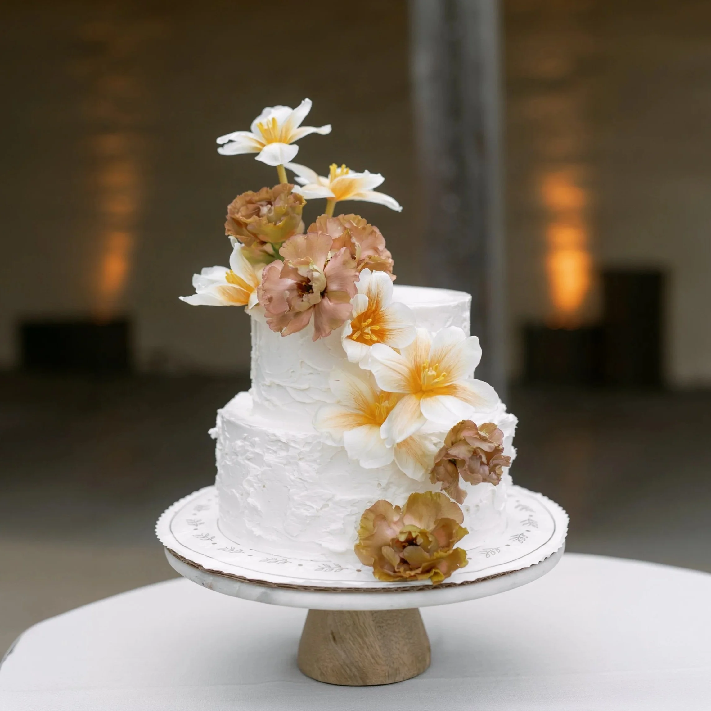 Two-tier celebration cake with sugar flowers from Lilac Montecito