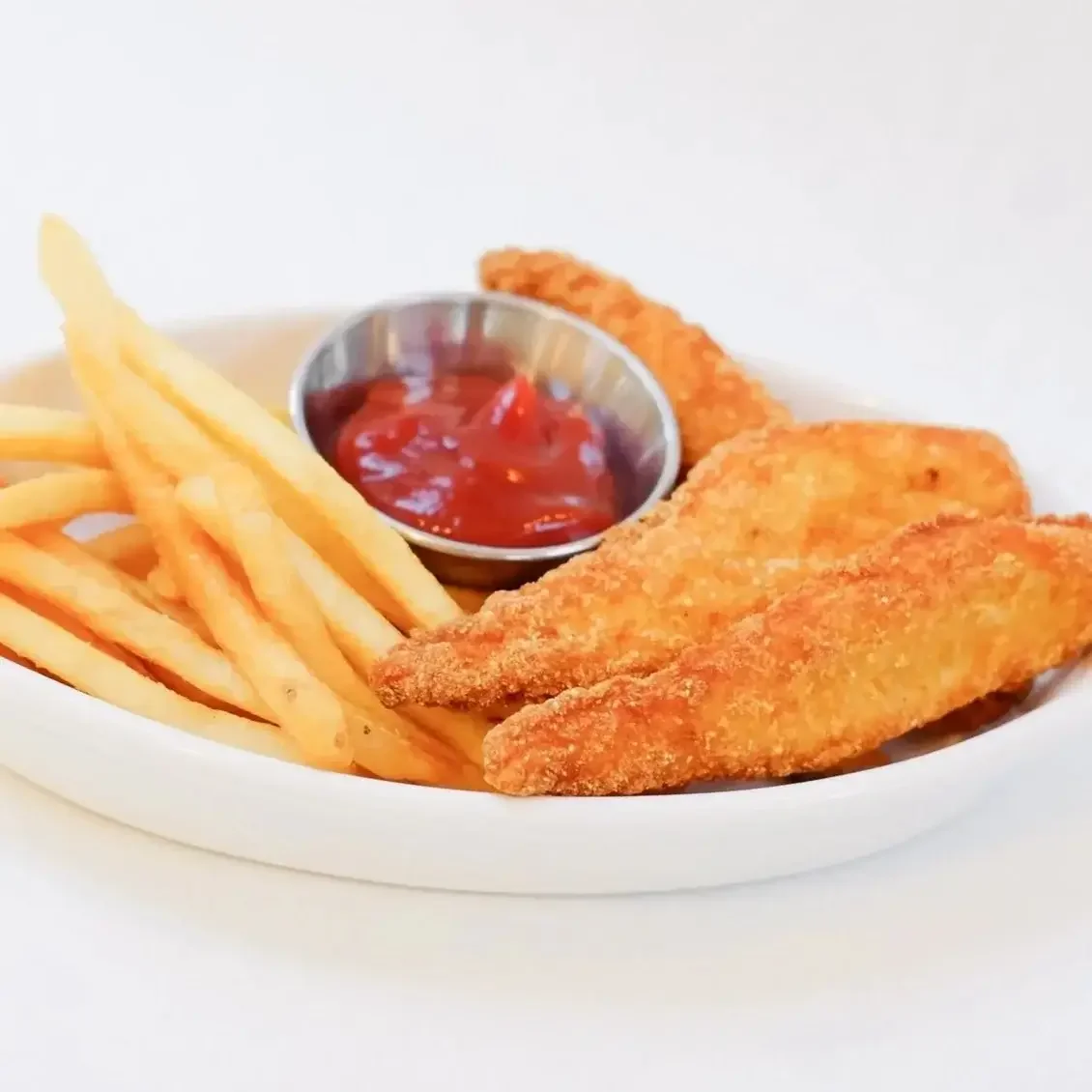 Crispy chicken tenders and french fries with a side of ketchup at Lilac Montecito restaurant in Montecito.