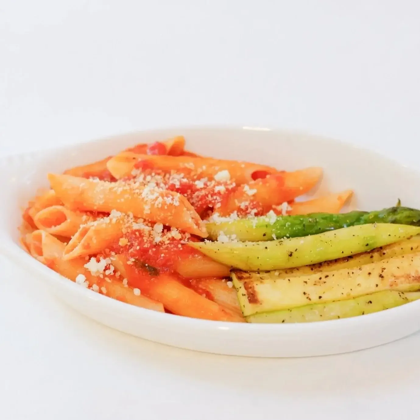 Kid-friendly penne pasta with tomato marinara sauce and parmesan, served with roasted asparagus and zucchini at Lilac Montecito.