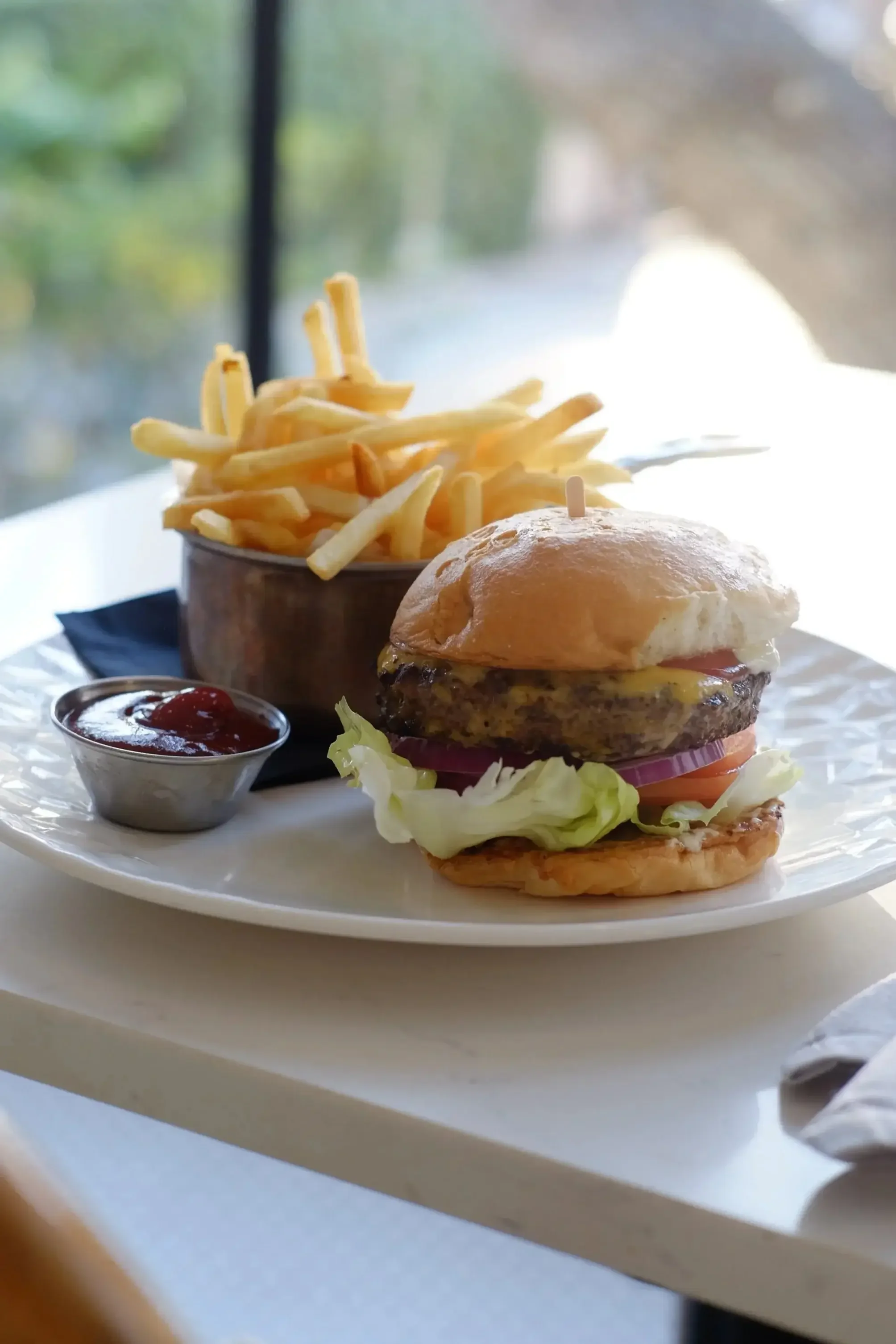 Burger with fries from the lunch menu at Lilac Montecito, a neighborhood restaurant in Montecito.