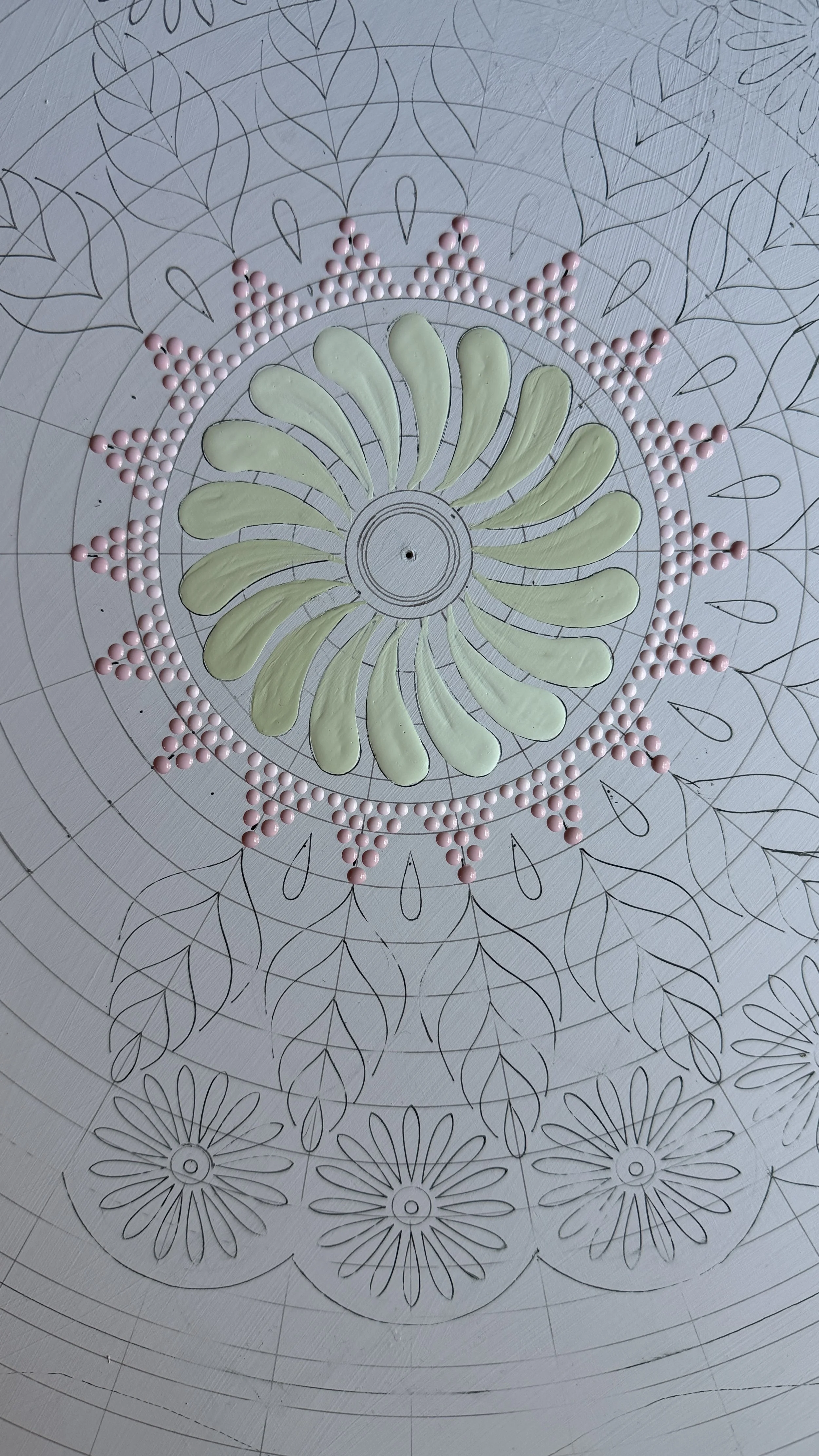 A stencilled mandala design in progress