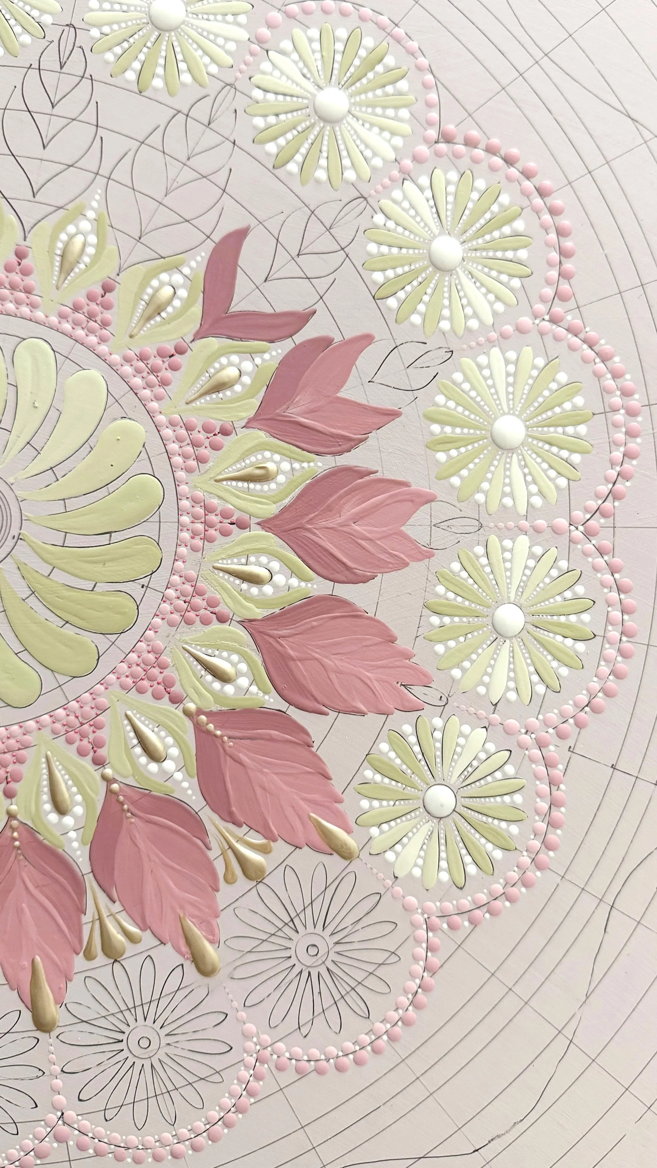 Colorful mandala design with pink, white, and yellow floral and leaf patterns, intricate line work, and decorative circular details.