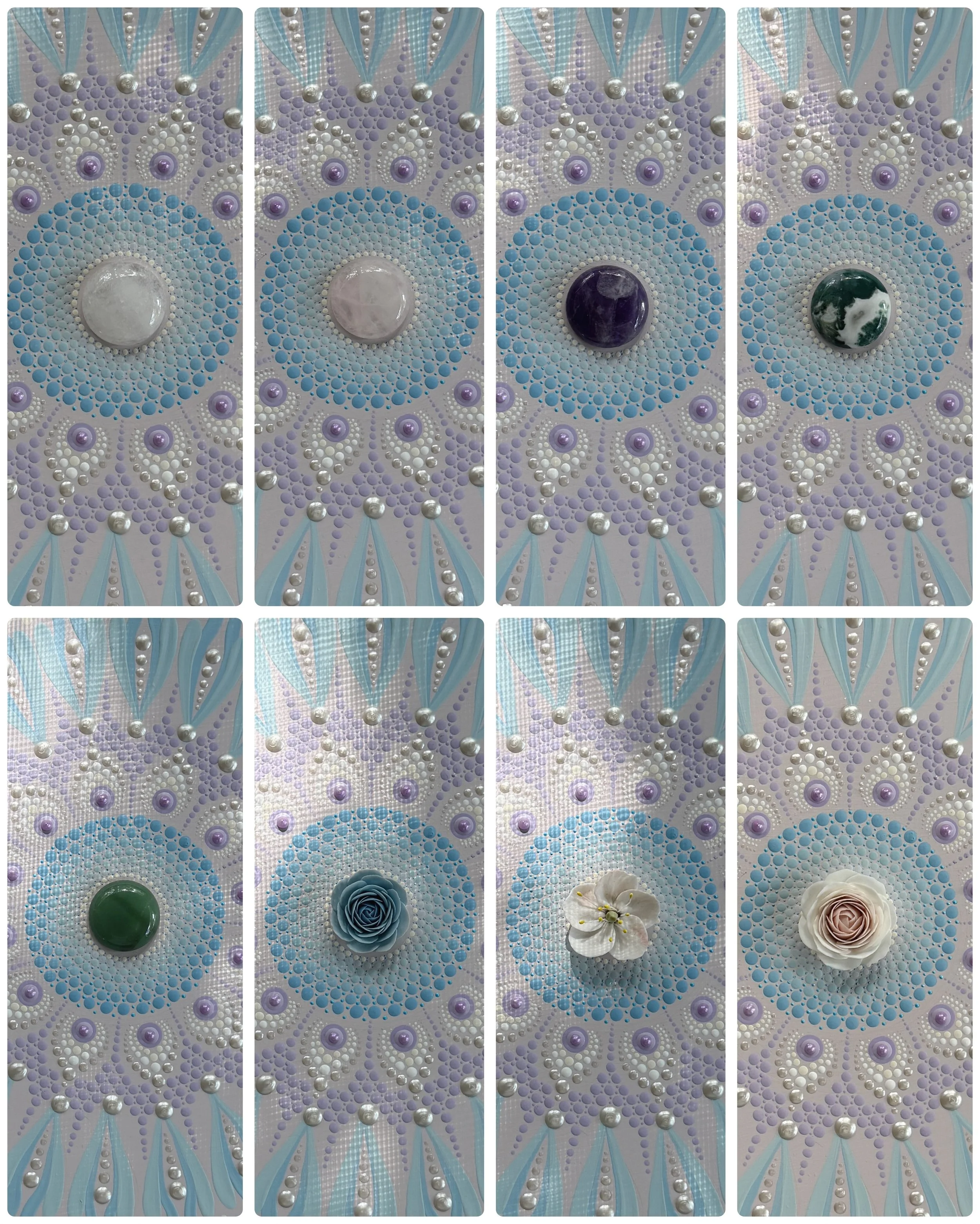 Decorative artwork featuring a symmetrical pattern of colored stones and flowers on a background with pastel blue, purple, white, and silver accents.