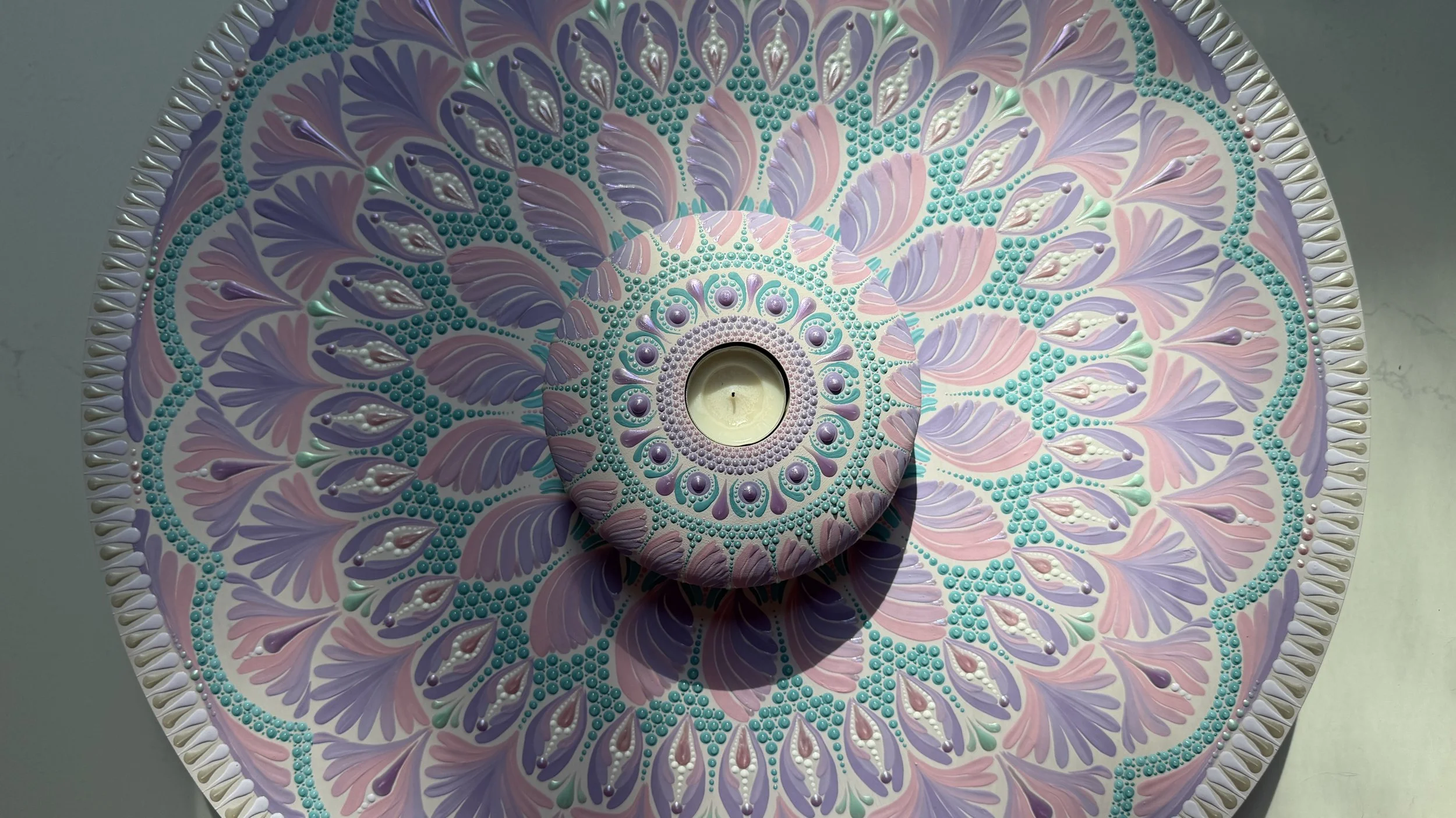 A large mandala with its matching tea light holder