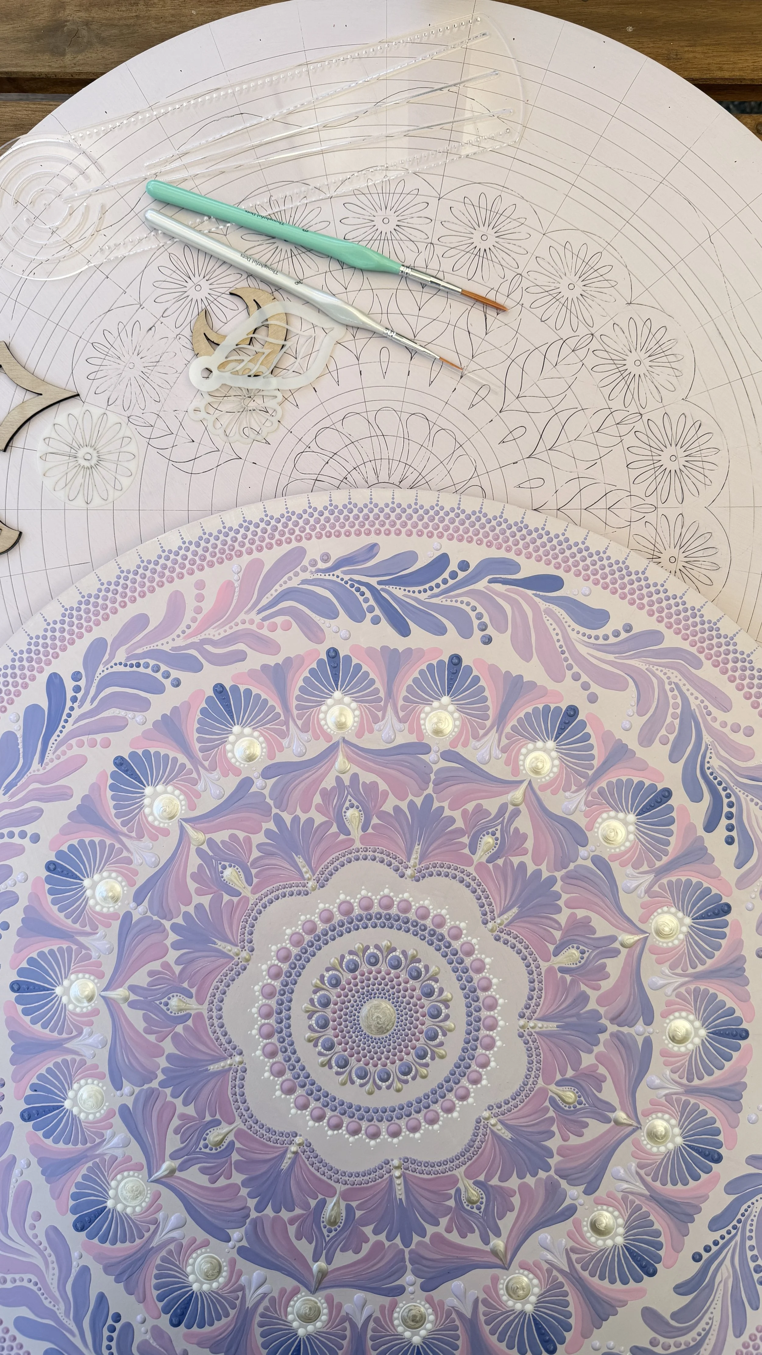 Hands painting a mandala