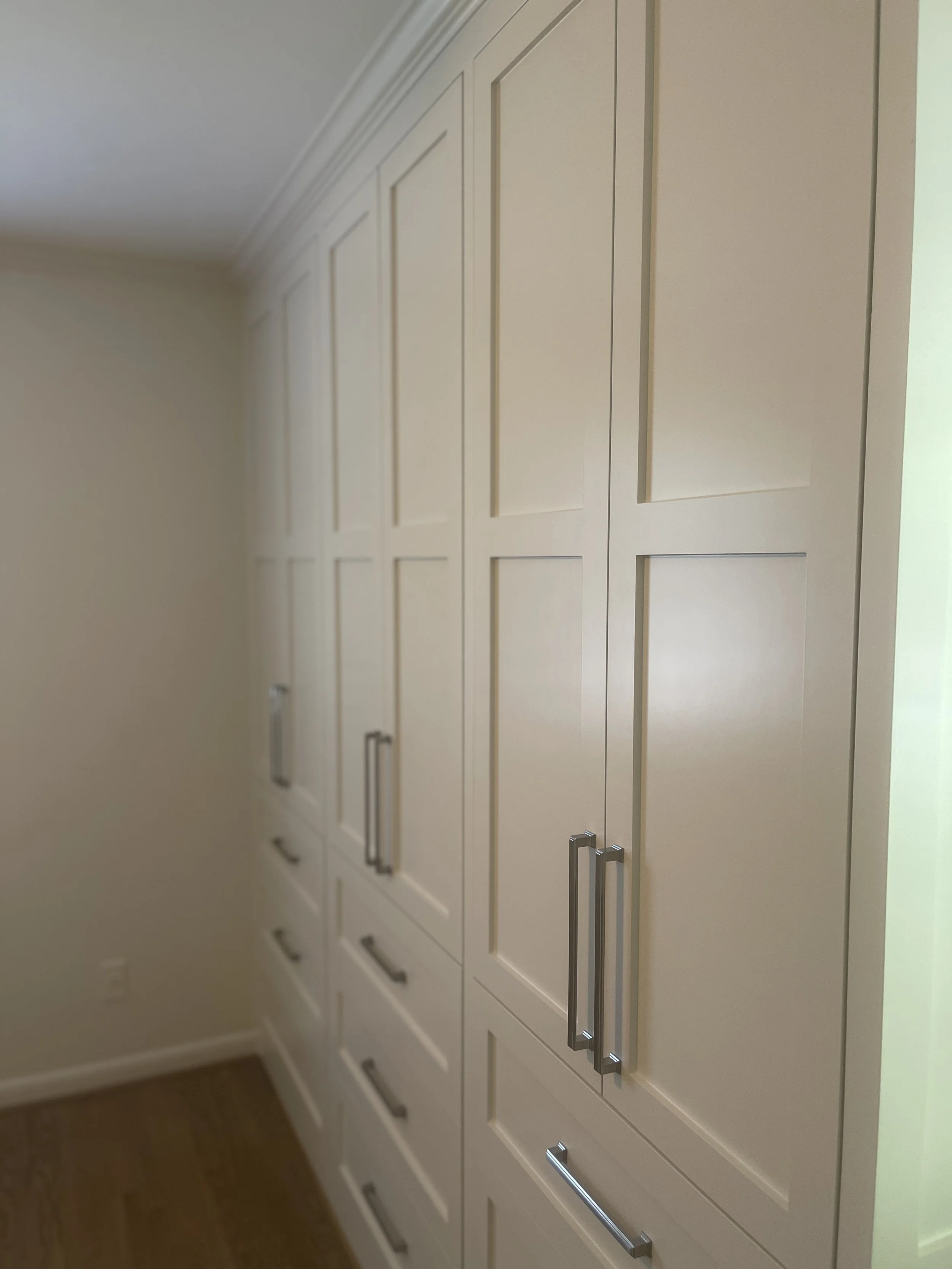 Custom Master Bedroom Armoire with upper hanging storage and lower drawer storage with a custom air supply vent and HVAC technician access.