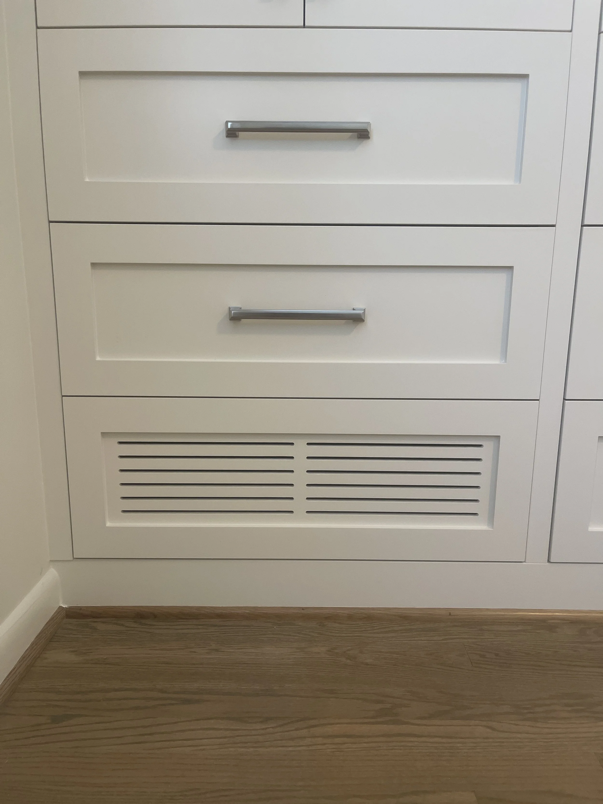 Custom Master Bedroom Armoire with upper hanging storage and lower drawer storage with a custom air supply vent and HVAC technician access.