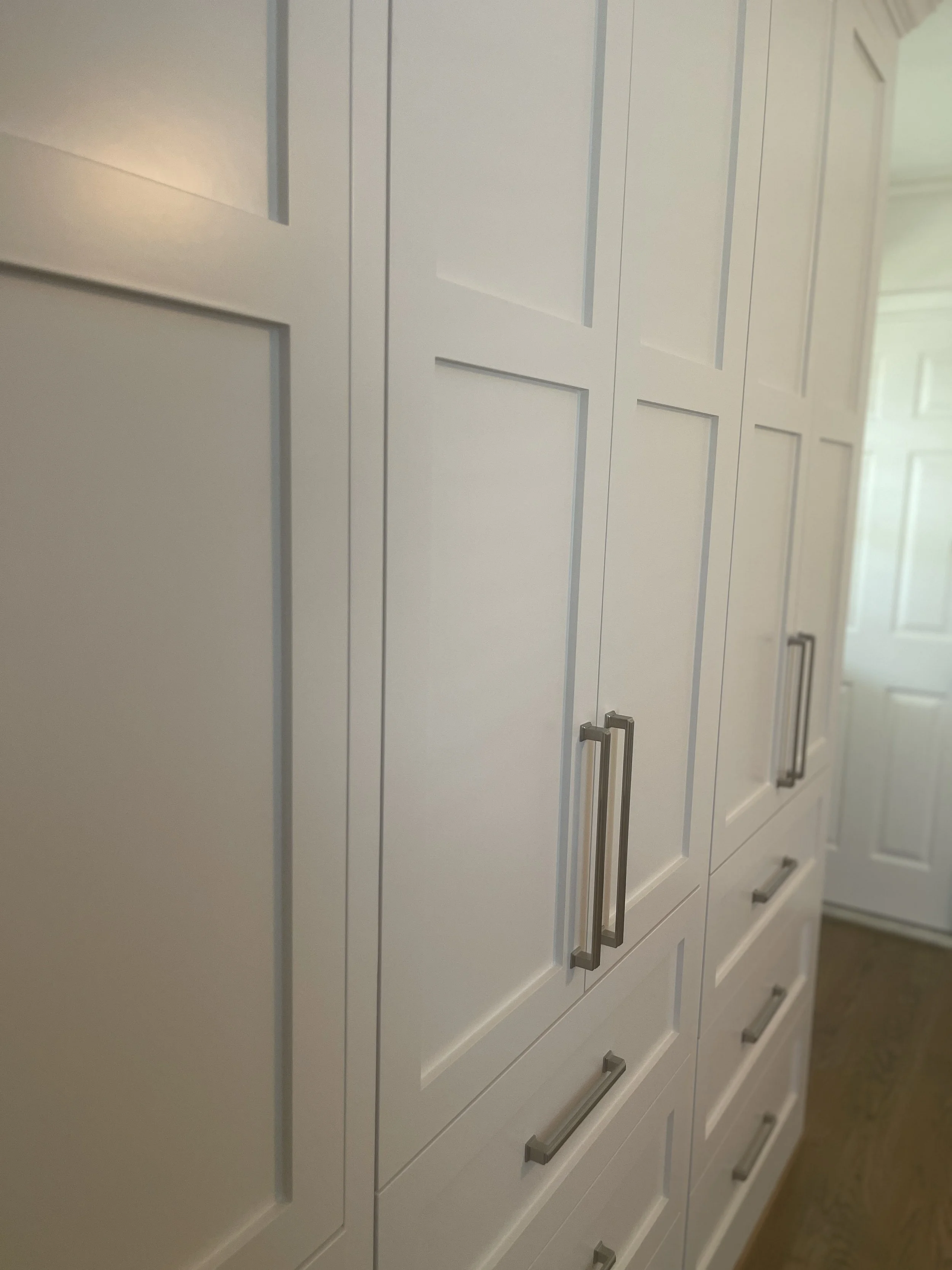 Custom Master Bedroom Armoire with upper hanging storage and lower drawer storage with a custom air supply vent and HVAC technician access.