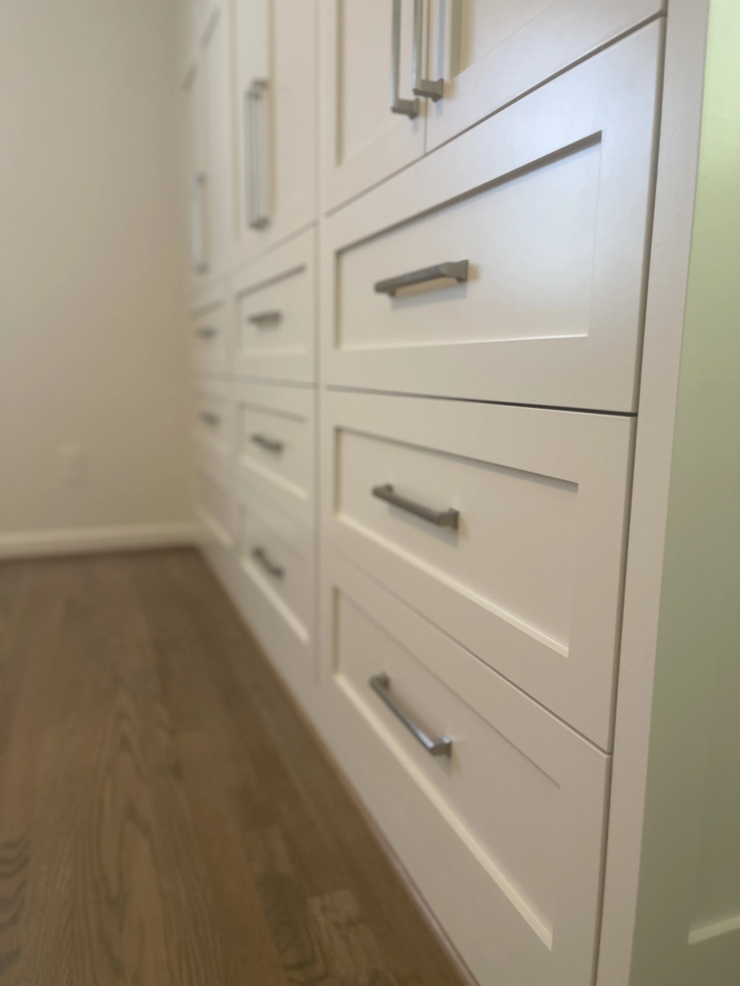 Custom Master Bedroom Armoire with upper hanging storage and lower drawer storage with a custom air supply vent and HVAC technician access.